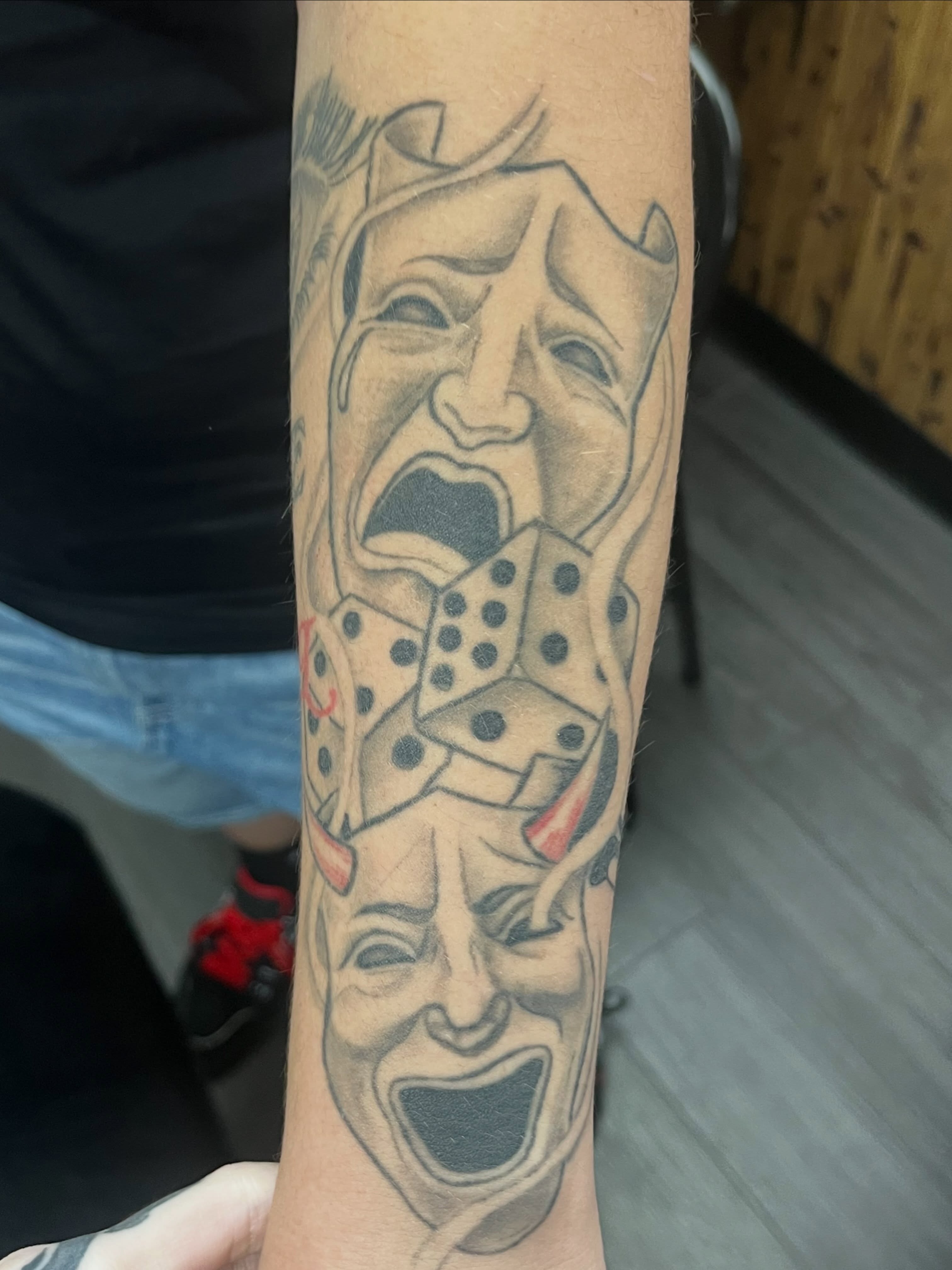 Joker mask black and grey tattoo on the forearm by ᴴᴬᴺᴺᴬᴴ ᴿᵁᴰᴰᴱᴸᴸ