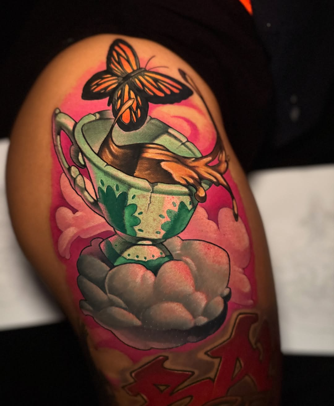 Teacup and butterfly new school tattoo on the upper arm by BigTatty Kayne