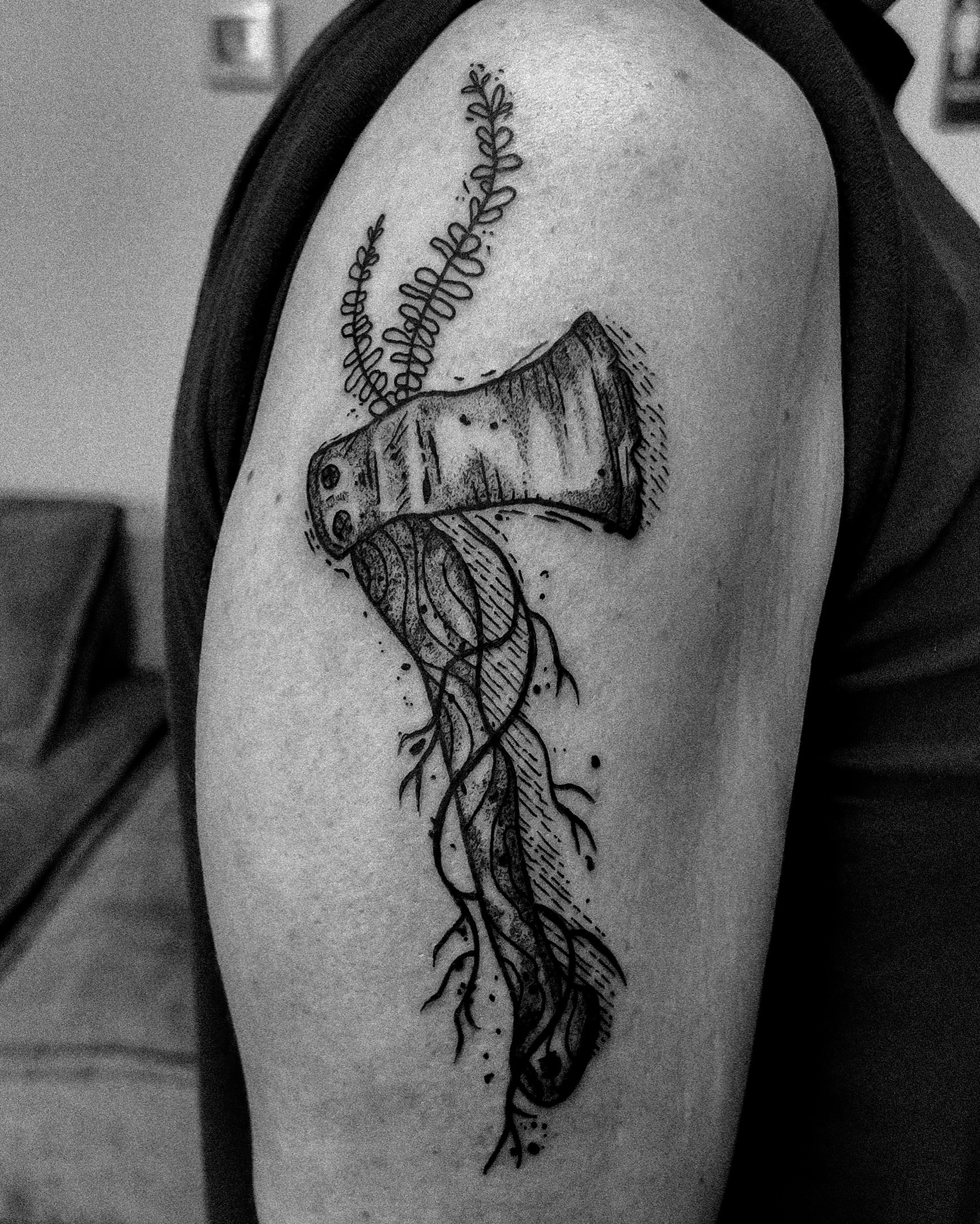 Axe with roots dotwork tattoo on the shoulder by Morgan Diann