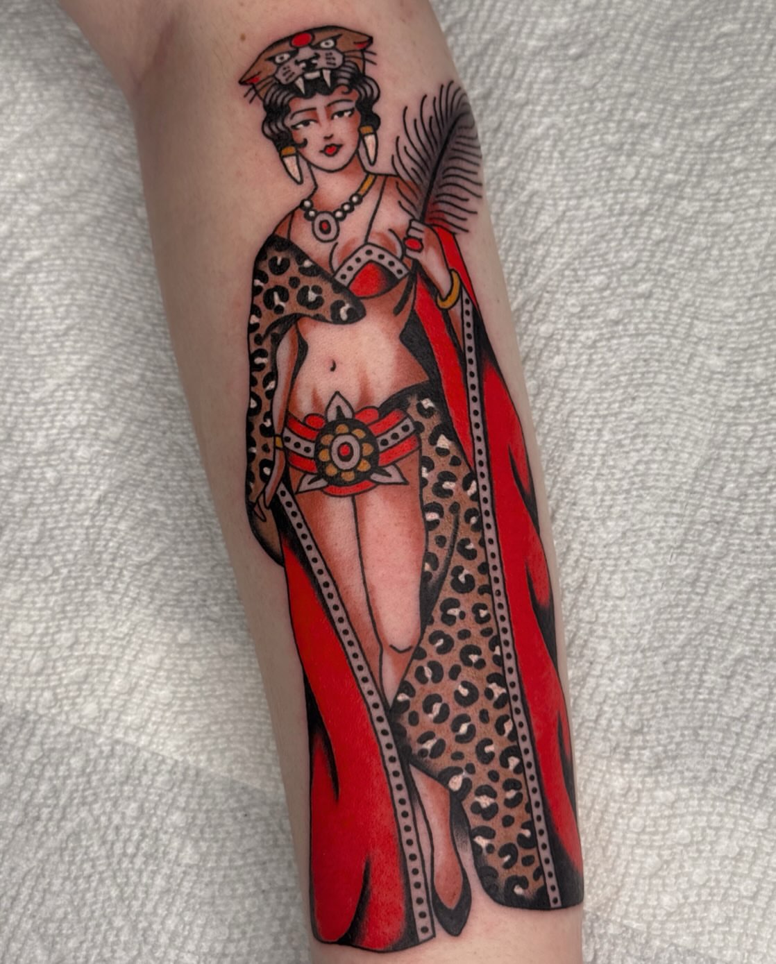 Woman in leopard print American traditional tattoo on the forearm by Bridgette Carberry