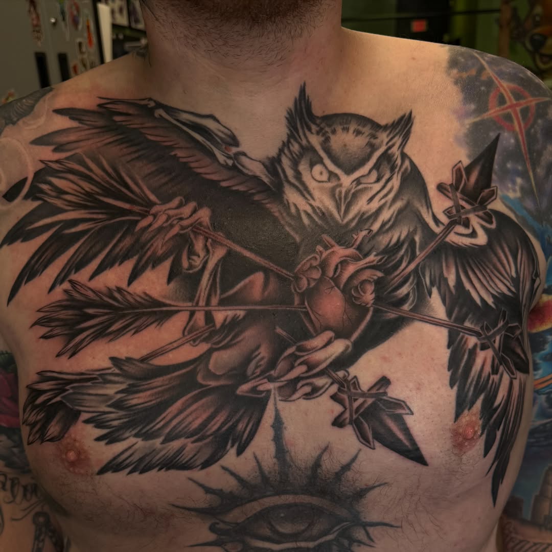 Owl and heart realism tattoo on the chest by Sam Minneci
