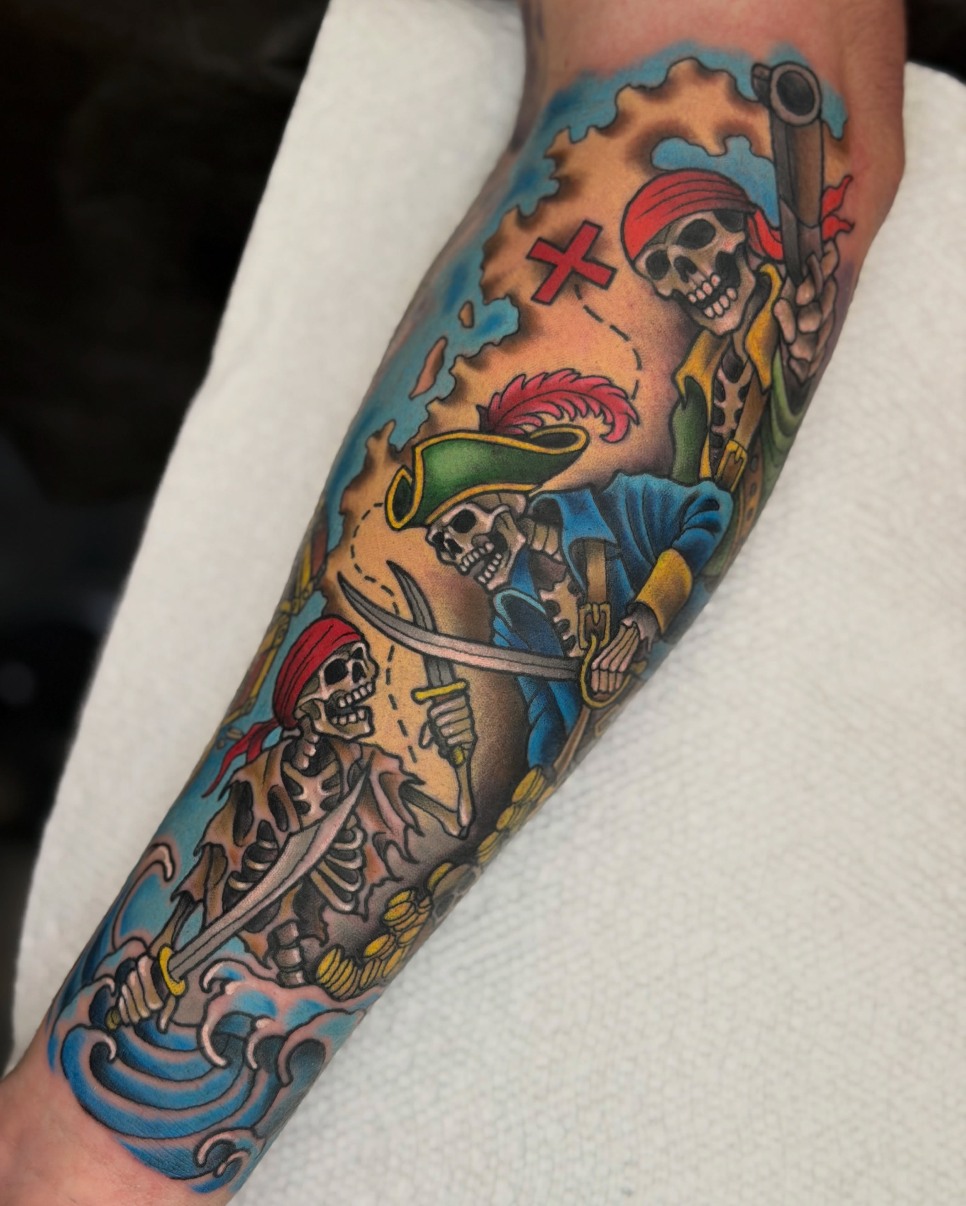 Pirate skeletons American traditional tattoo on the forearm by James Mullin
