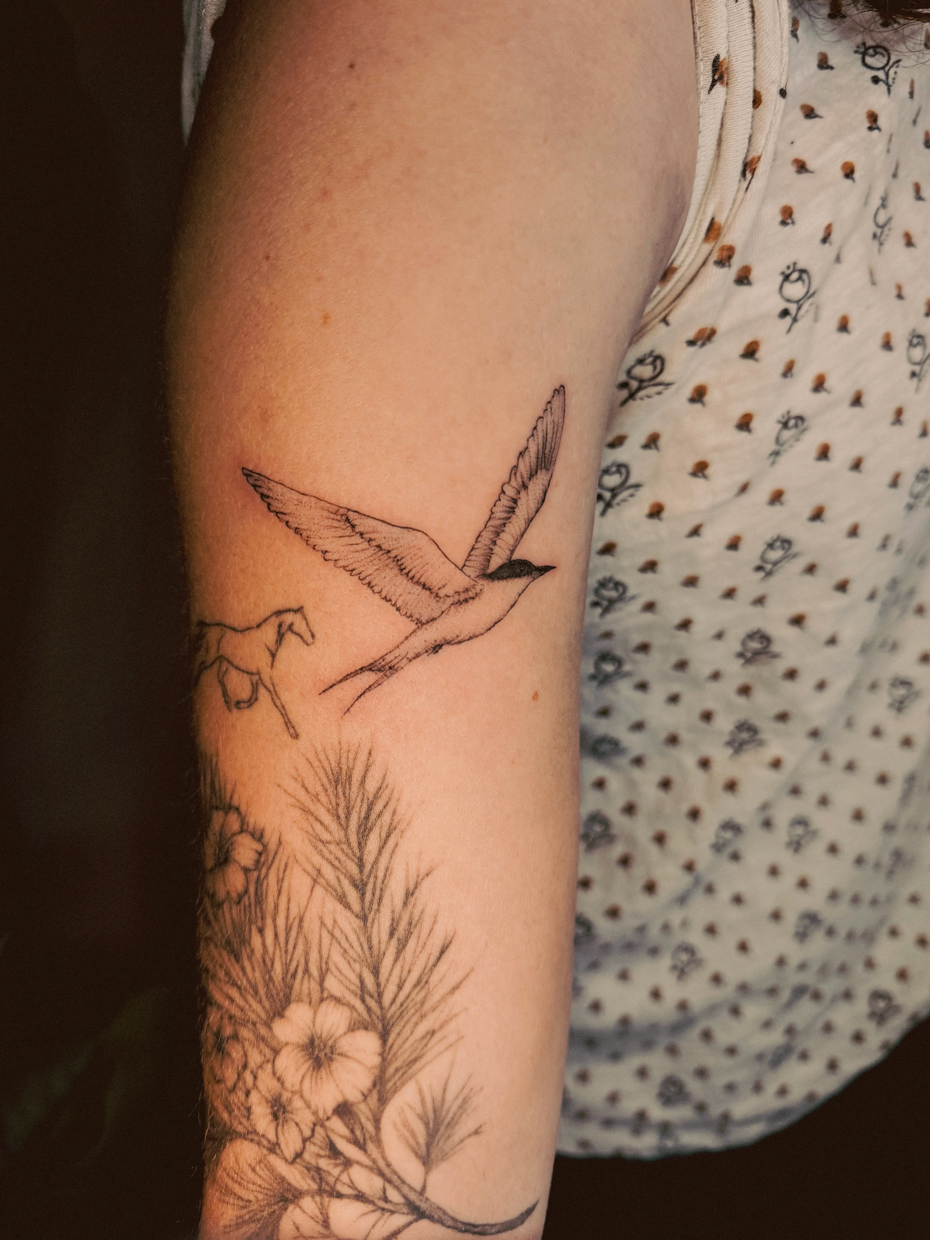 Bird flying realism tattoo on the forearm by Ashley Pilgreen