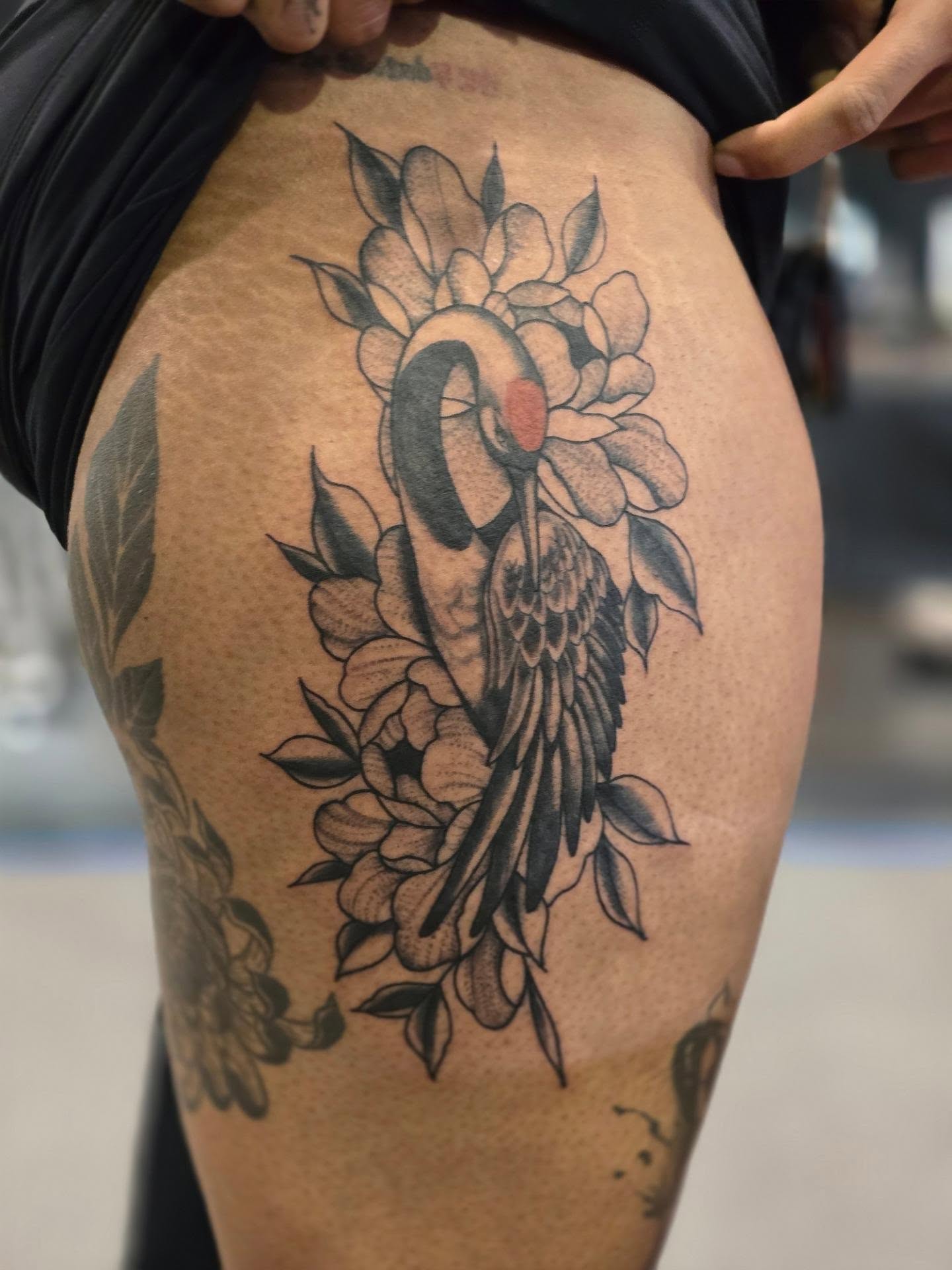 Flamingo and flowers black and grey tattoo on the thigh by Rachel, Centereach, New York