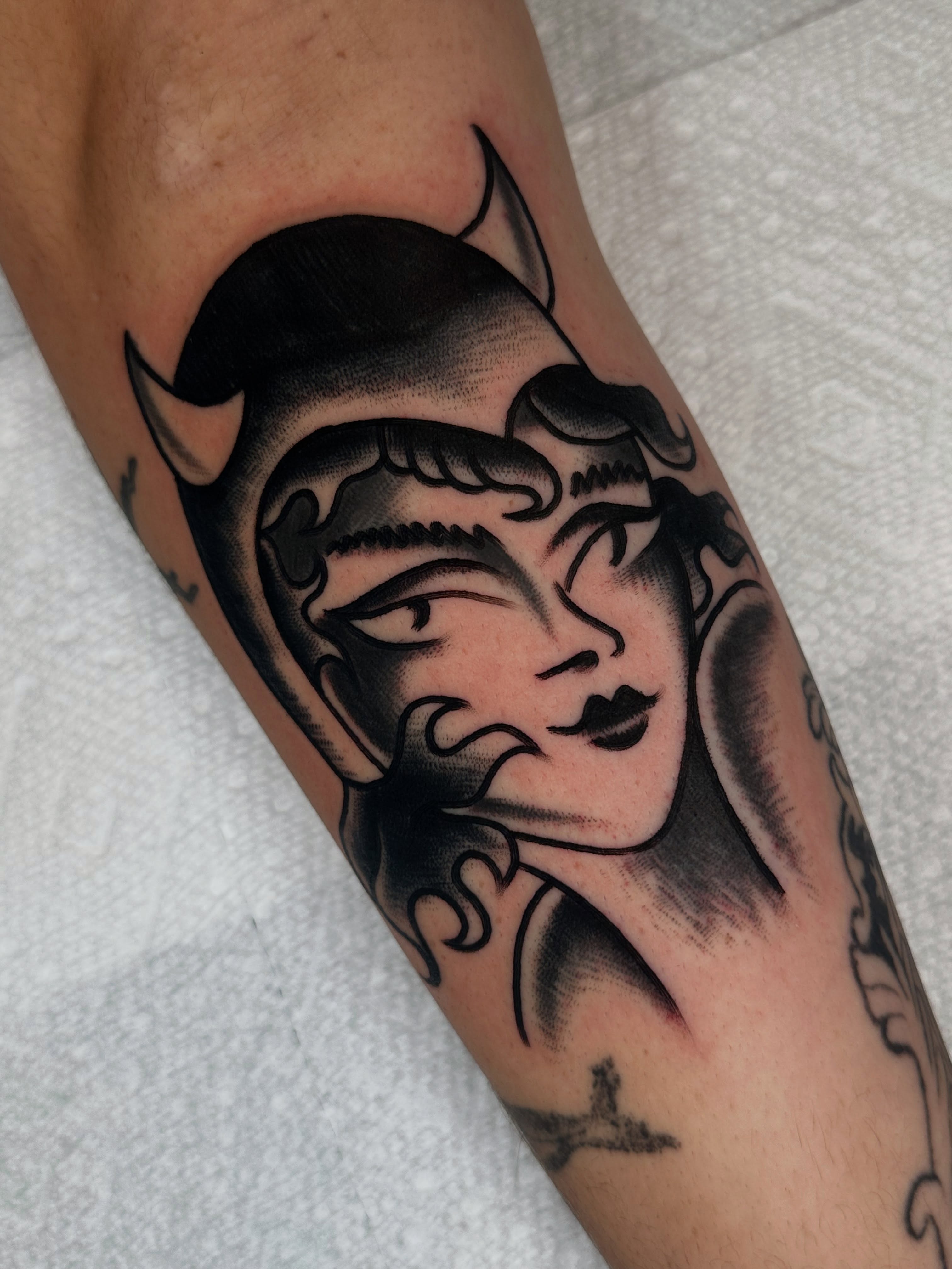 Man's face American traditional tattoo on the forearm by Spencer Crawford, Speedway, Indiana