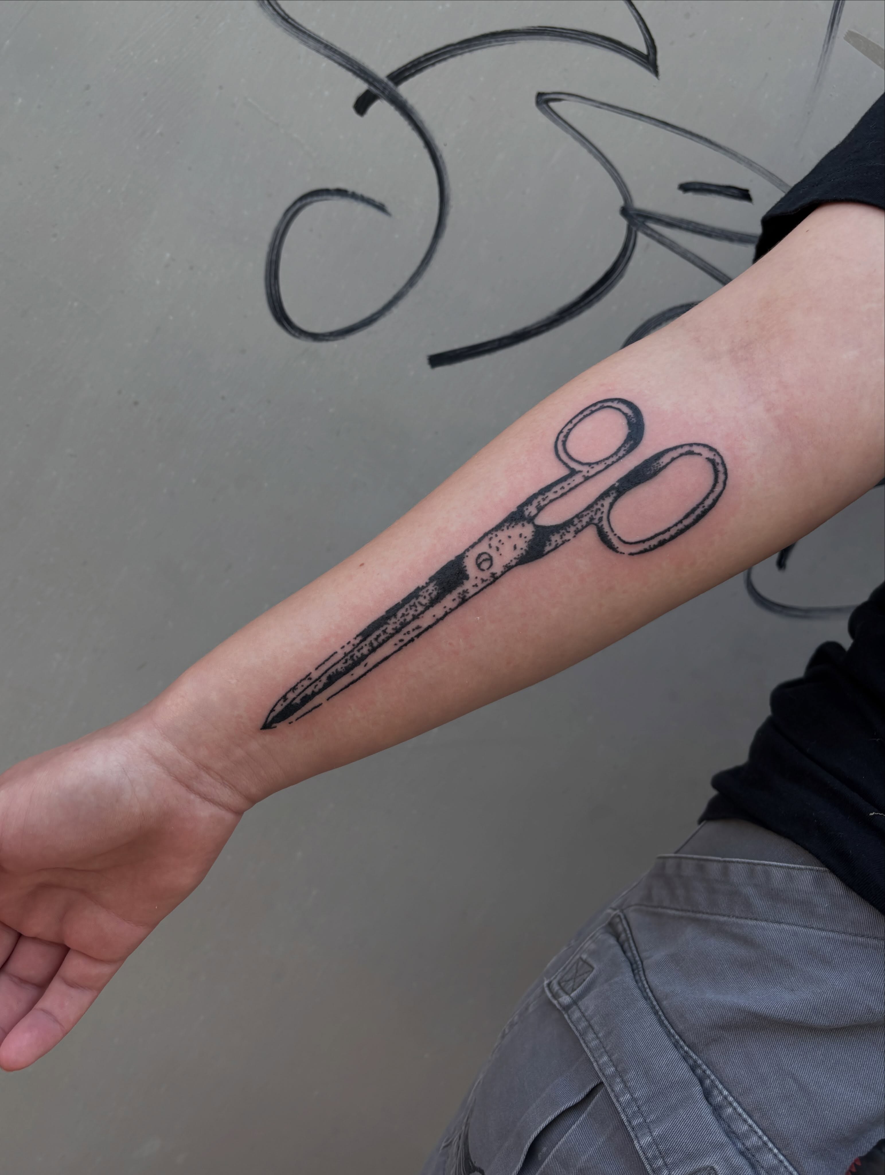 Scissors black and grey tattoo on the forearm by Turner