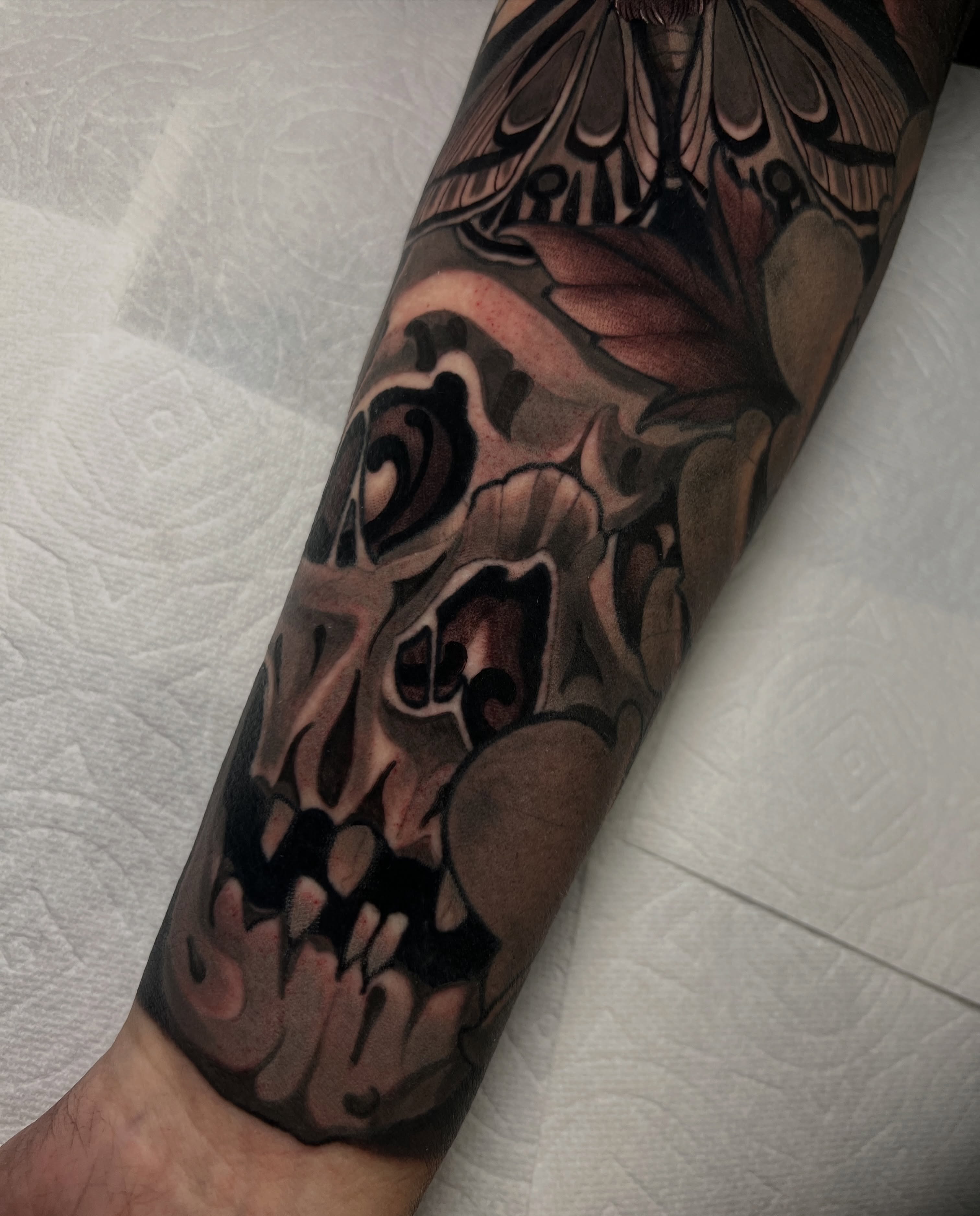 Skull dark realism tattoo on the forearm by Rennie Tattoo