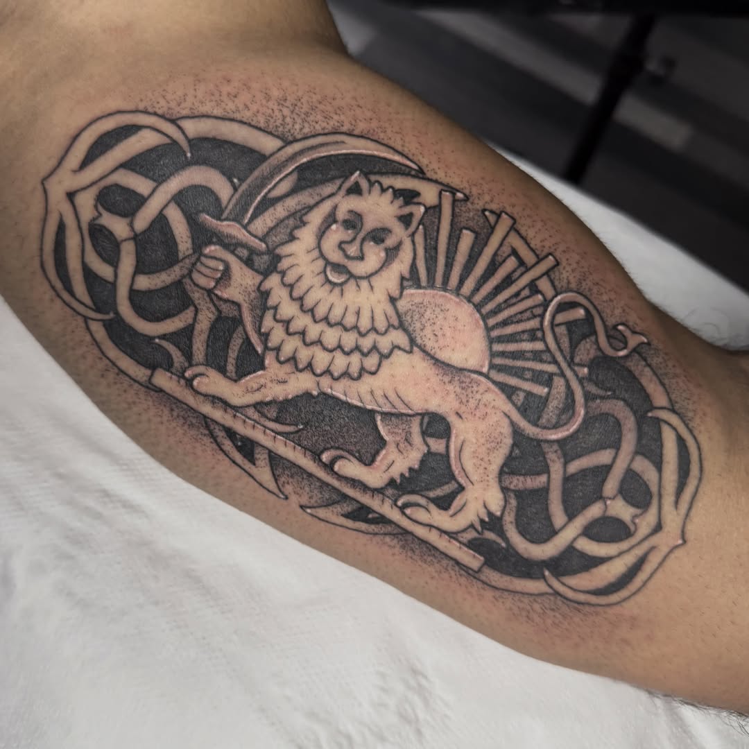 Lion and celtic knot black and grey tattoo on the forearm by Aiden Shaw