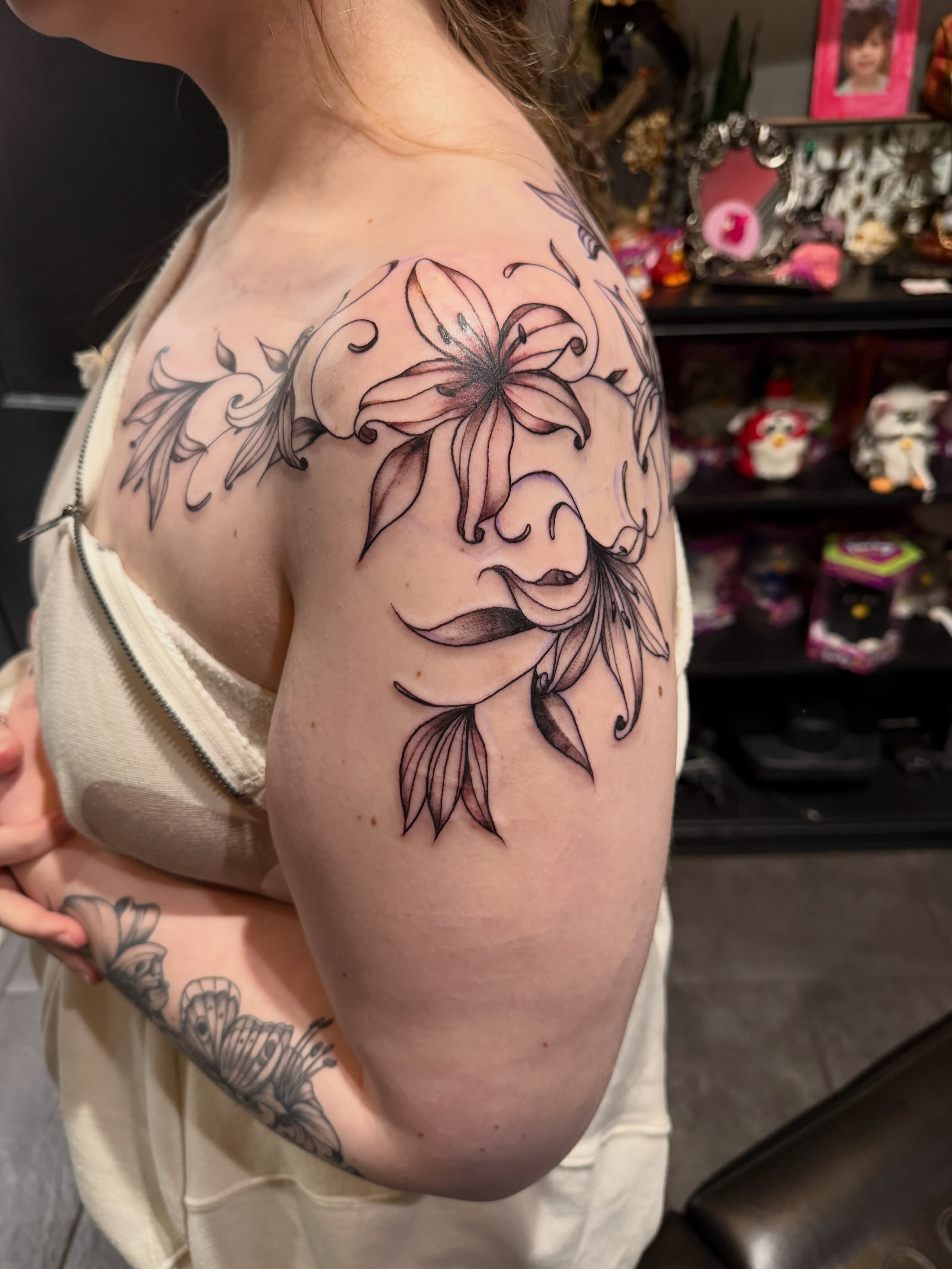 Lily black and grey tattoo on the shoulder by Courtney