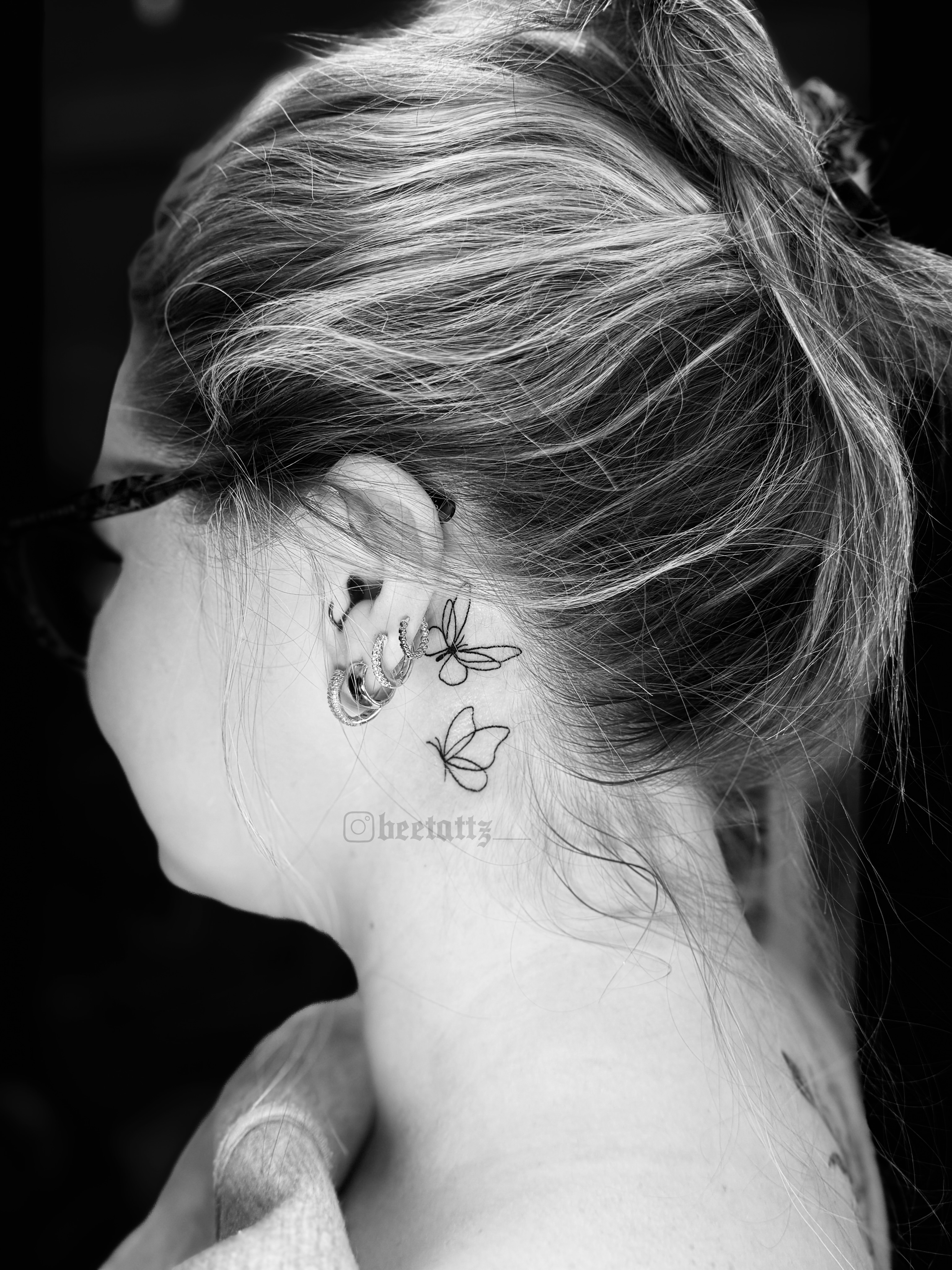 Butterfly black and grey tattoo on the neck by Brinkley McGill