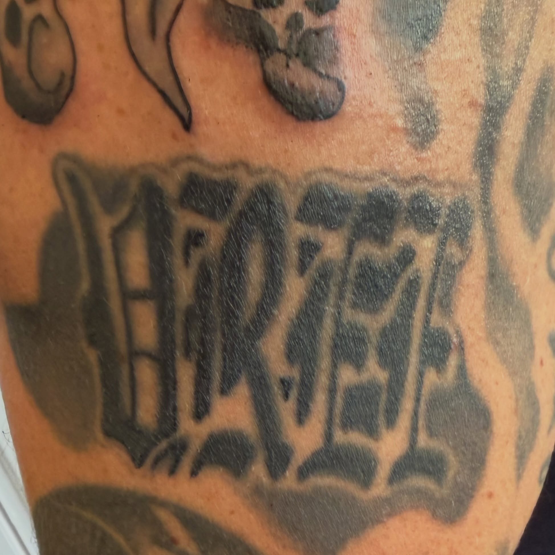 Lettering black and grey tattoo on the forearm by Addison Bruce