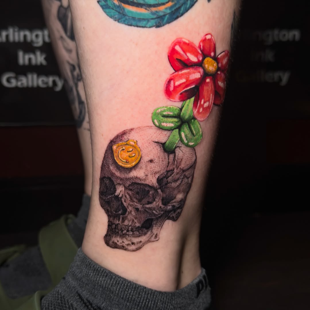 Skull with flower realism tattoo on the forearm by Neeko