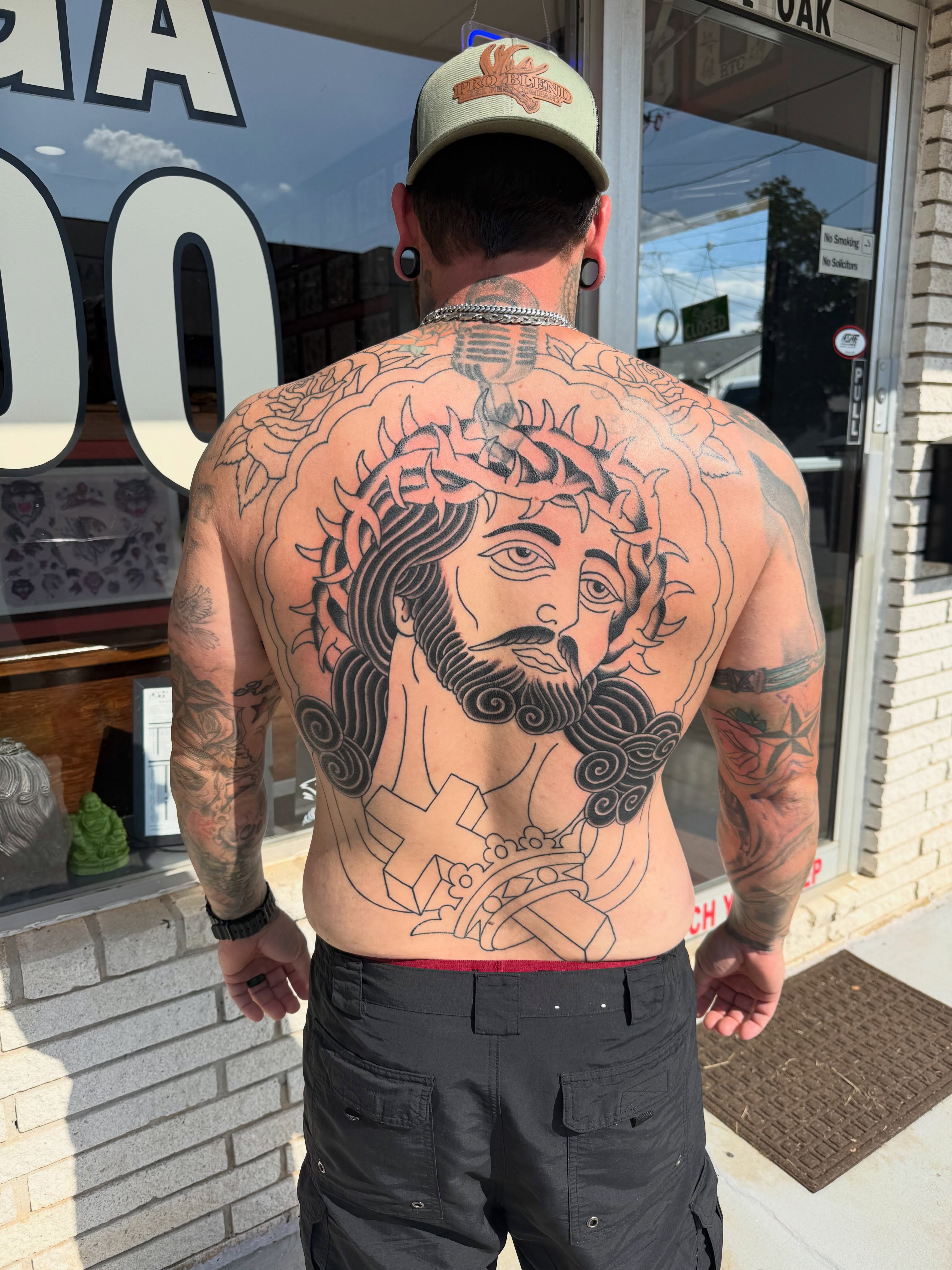 Religious figure black and grey tattoo on the back by Cody Dalton