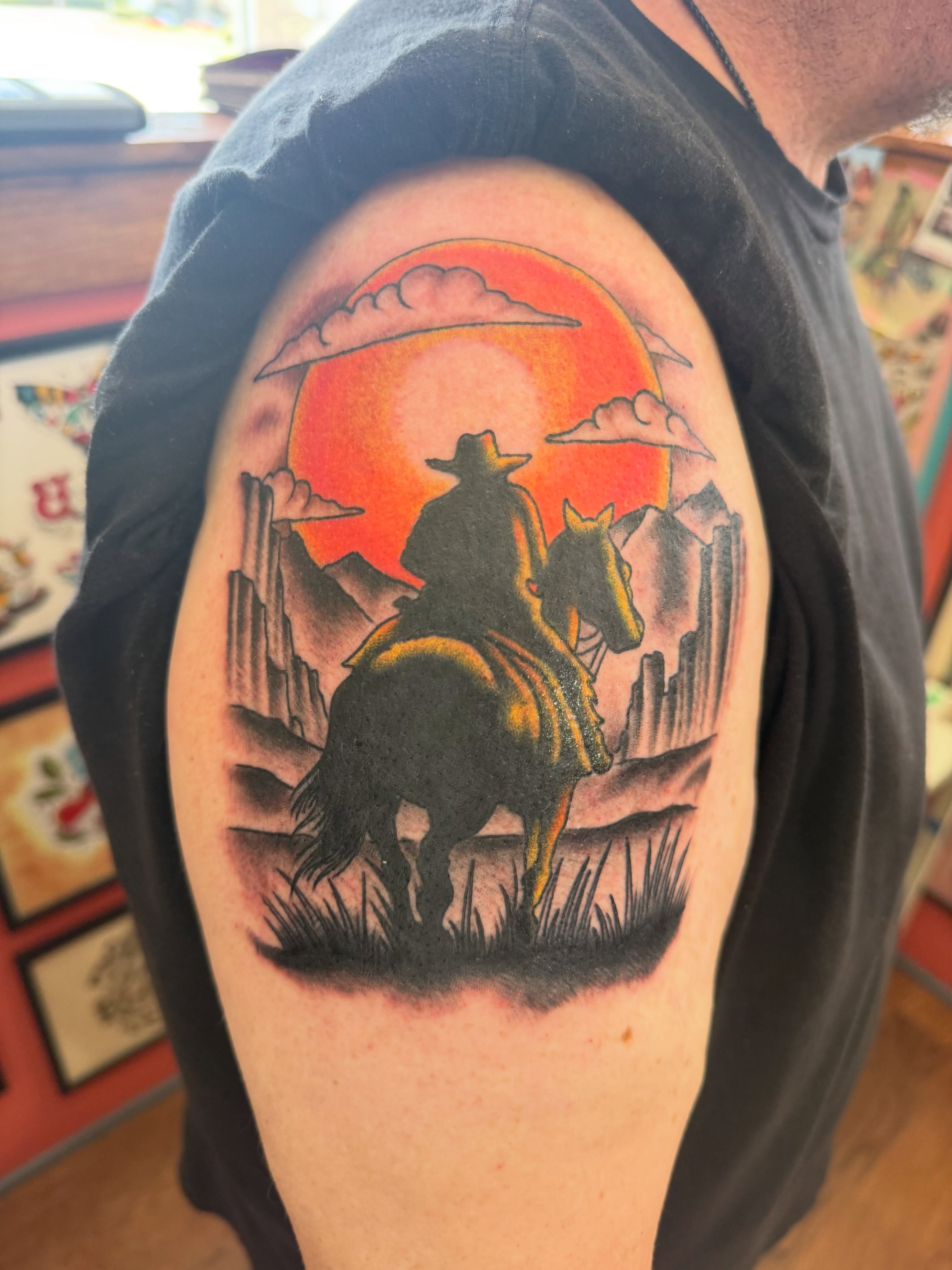 Cowboy on horse realism tattoo on the shoulder by Cody Dalton