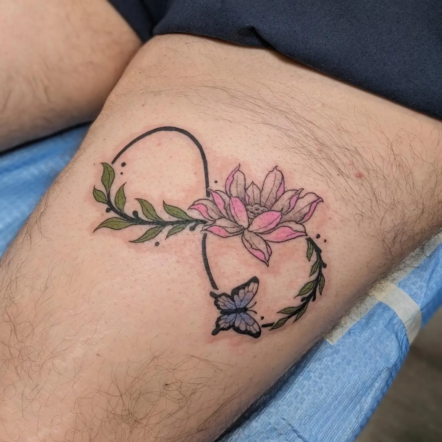 Lotus flower and butterfly dotwork tattoo on the thigh by Damon 🥀