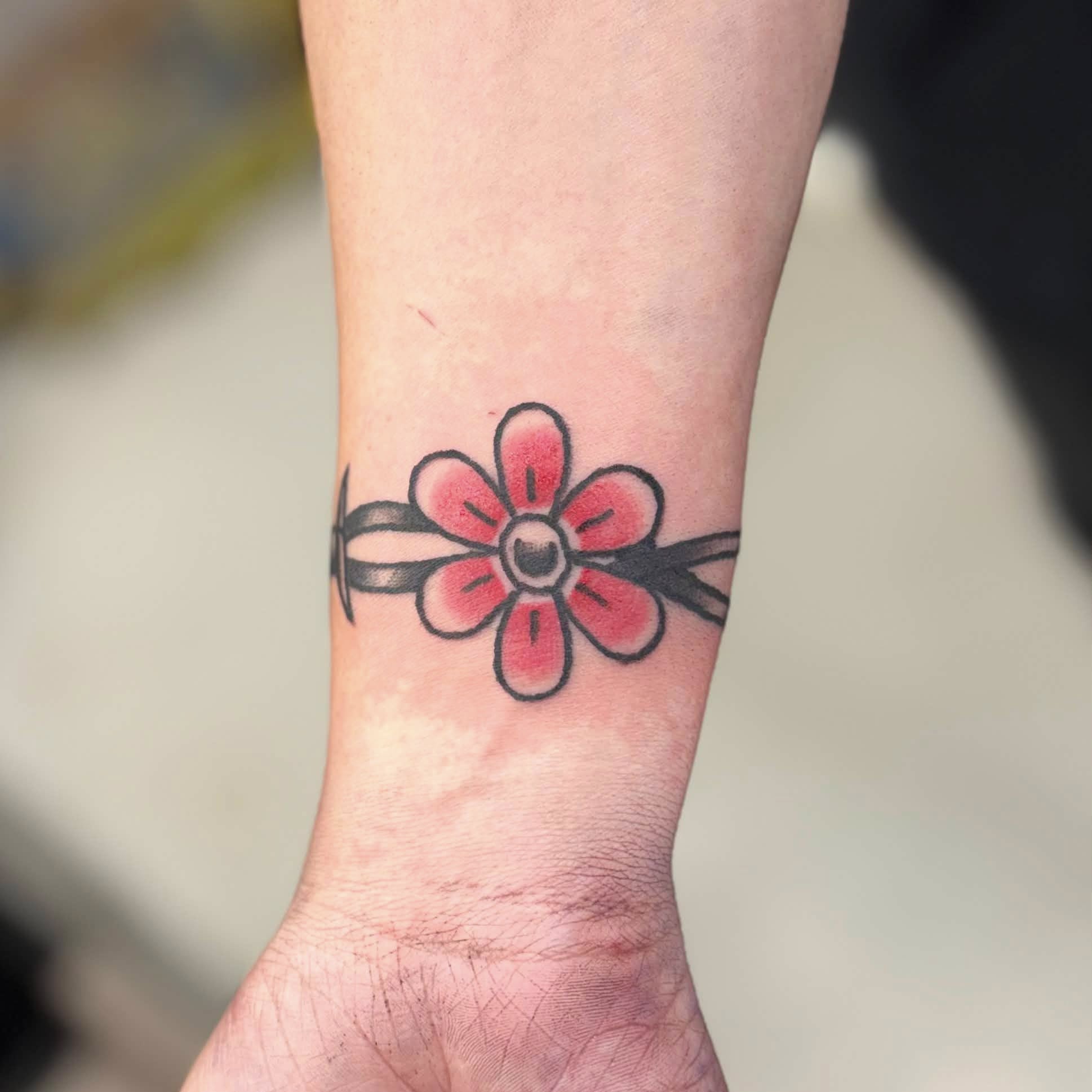 Flower American traditional tattoo on the forearm by Jon Anderson