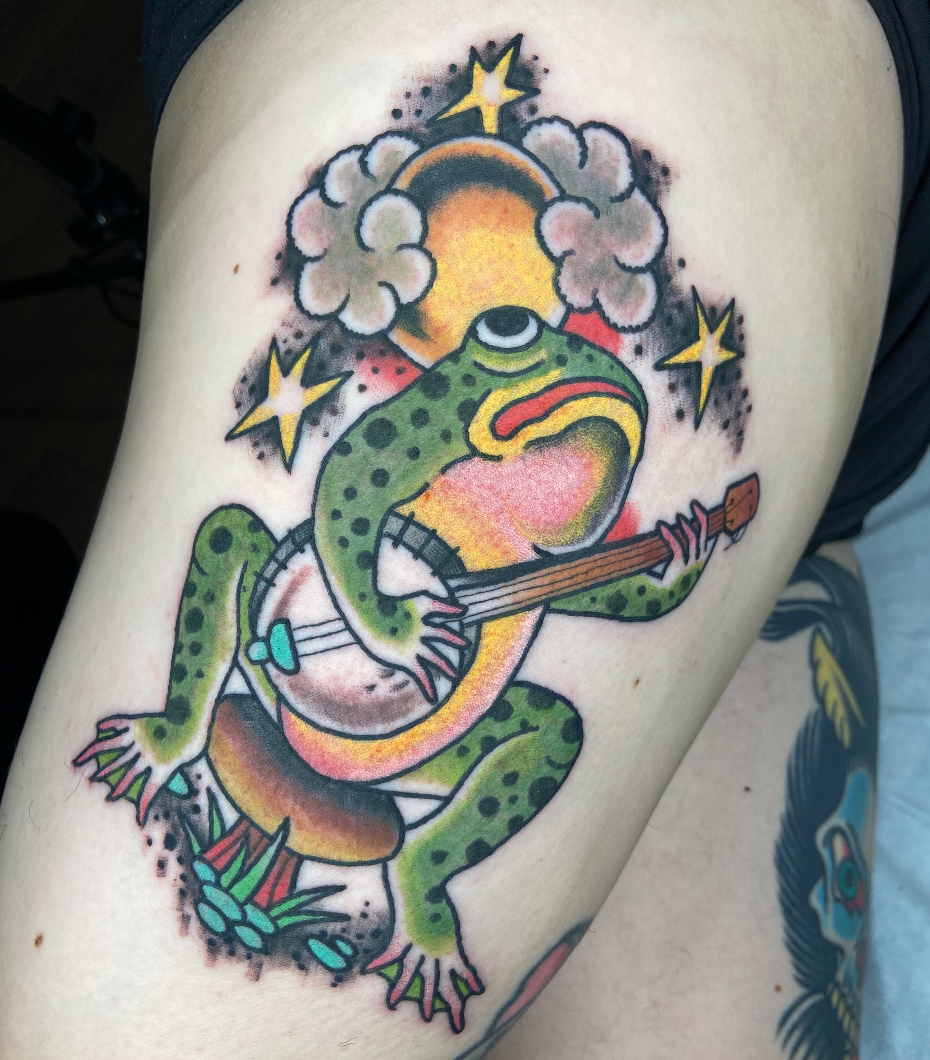 Frog playing guitar American traditional tattoo on the thigh by nicholas mcevoy, Boston, Massachusetts