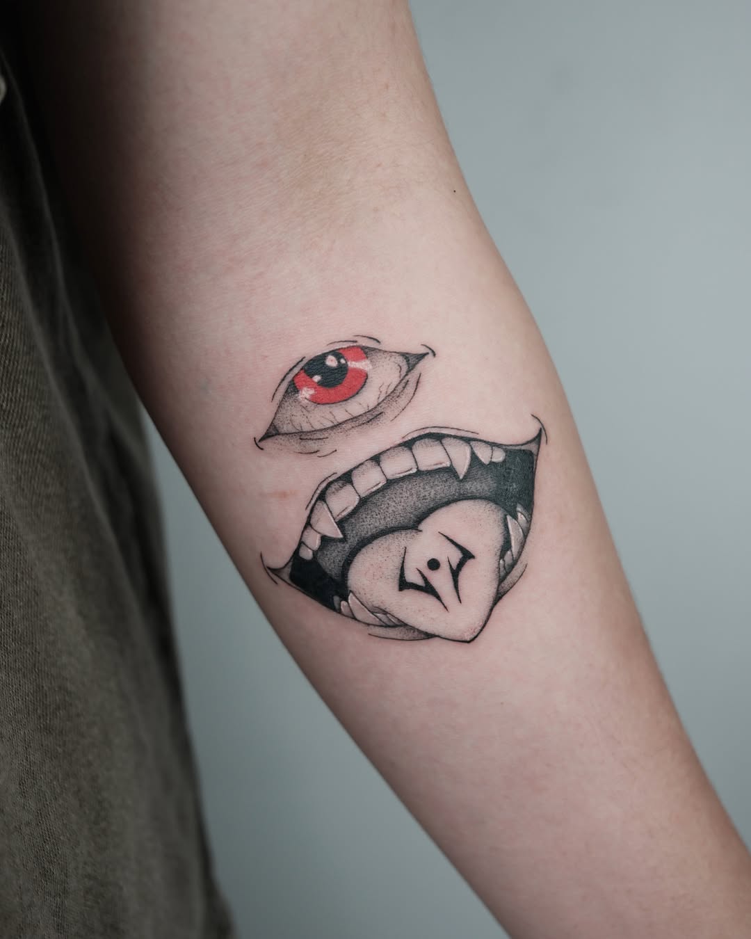 Eye and mouth dotwork tattoo on the forearm by Vu Nguyen