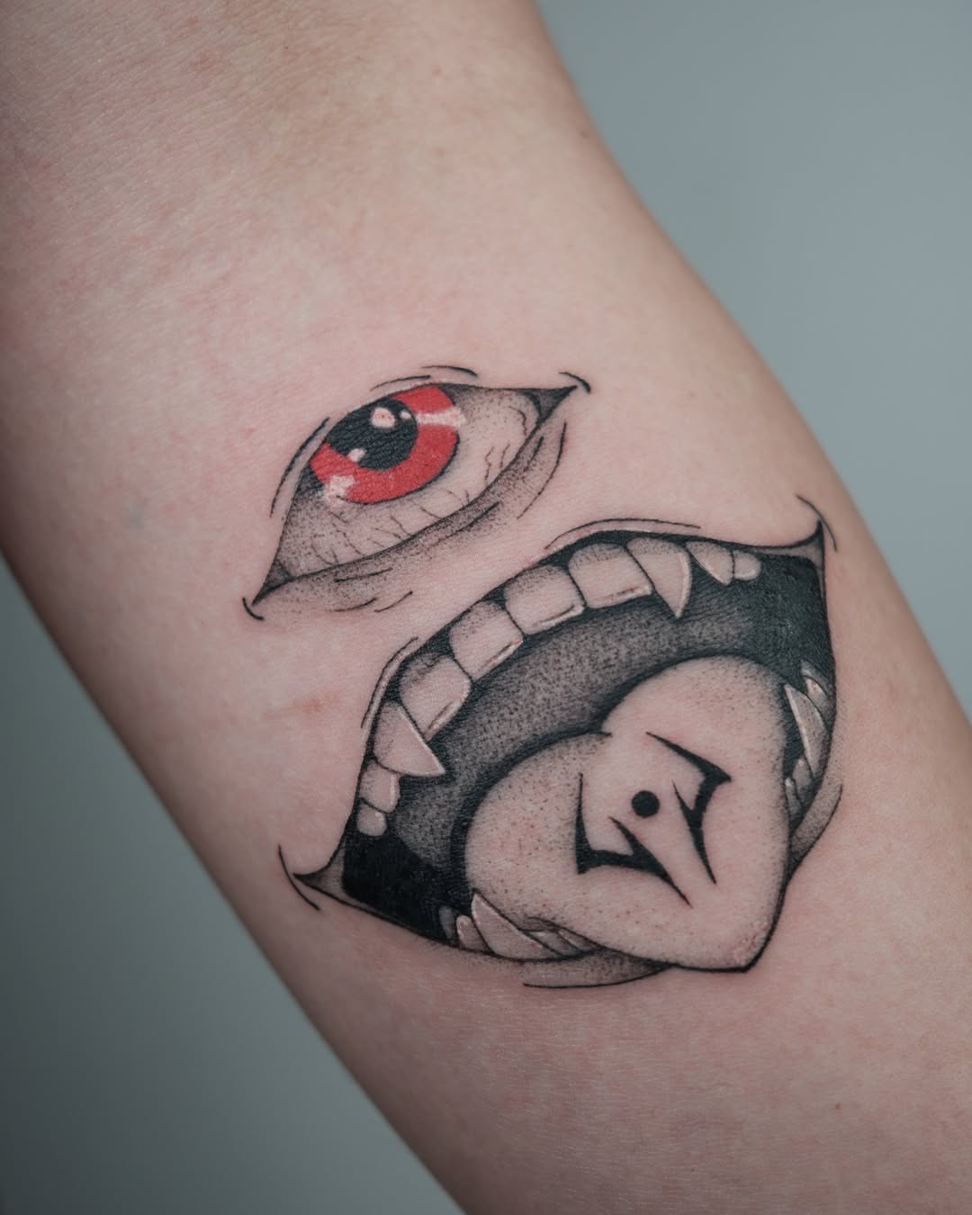 Eye and mouth dotwork tattoo on the forearm by Vu Nguyen