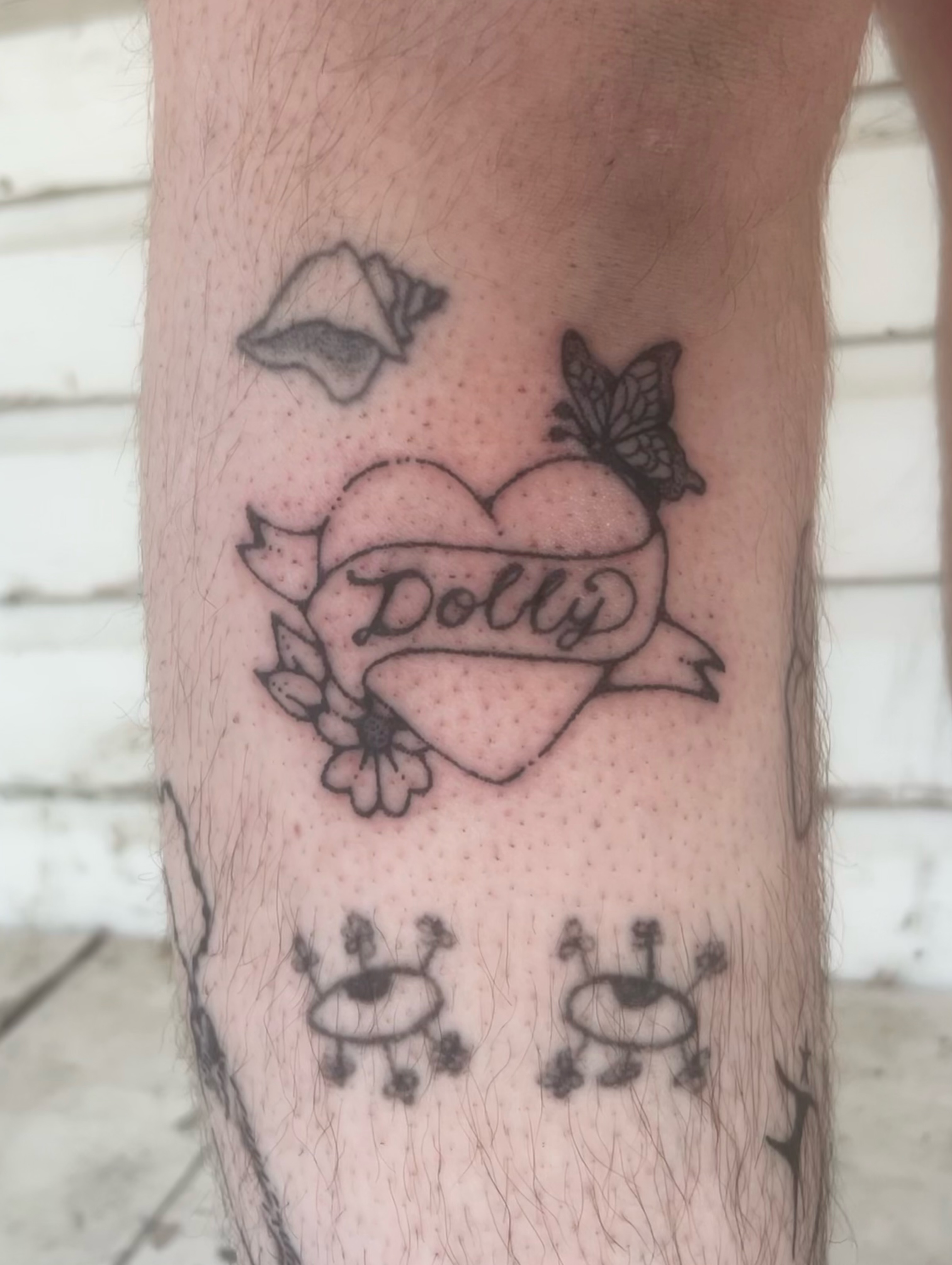 Heart with name American traditional tattoo on the forearm by silas