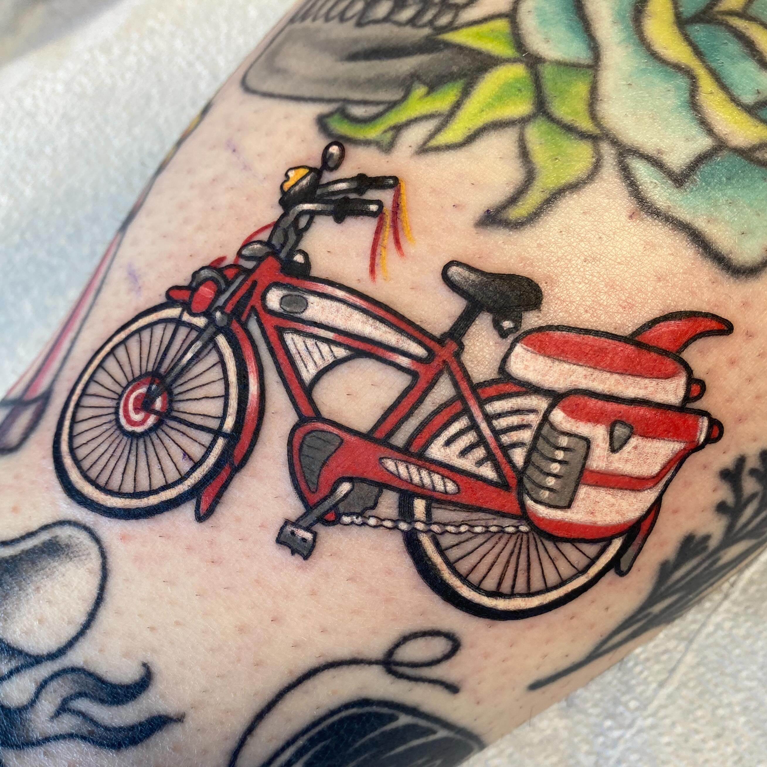 Red bicycle American traditional tattoo on the forearm by Kellsey Mull