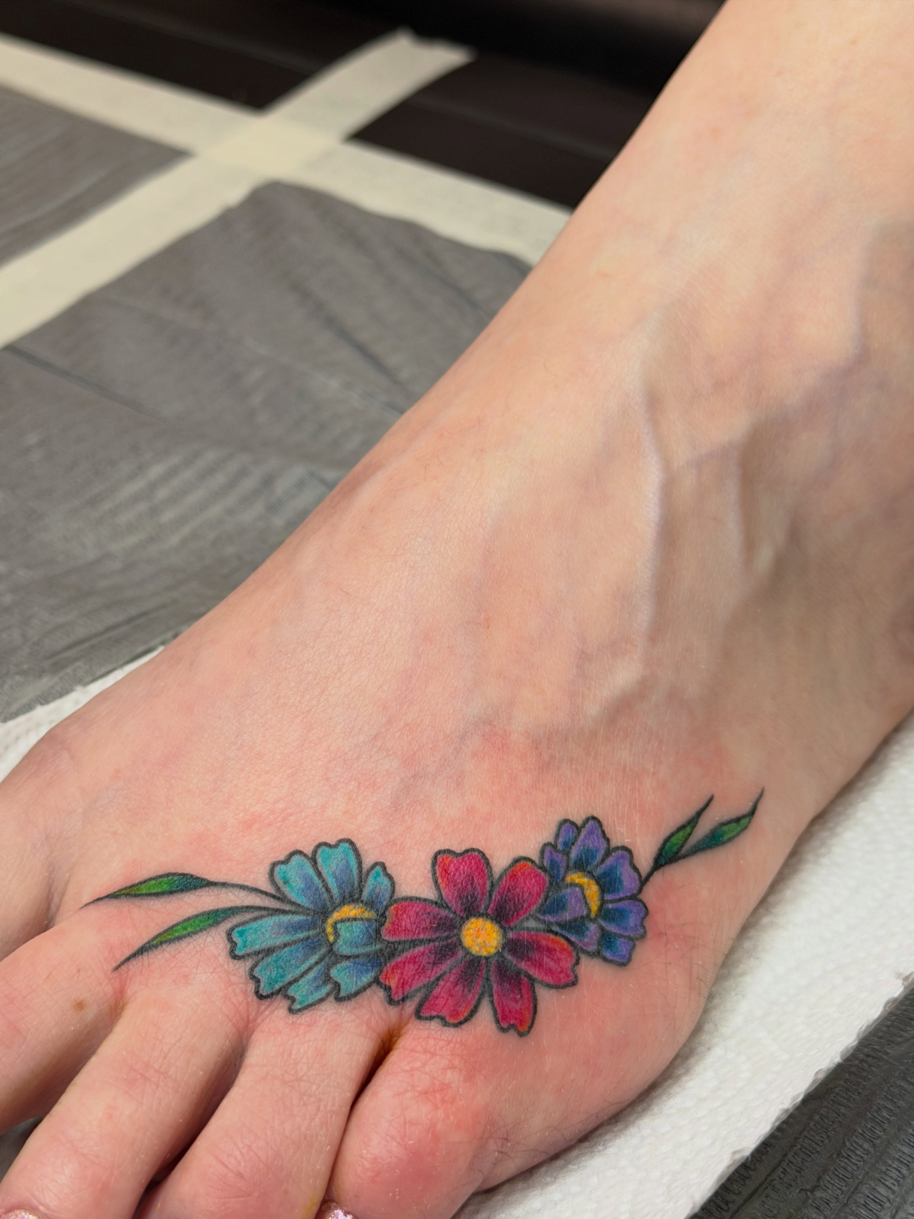 Flowers dotwork tattoo on the foot by Summer Christman