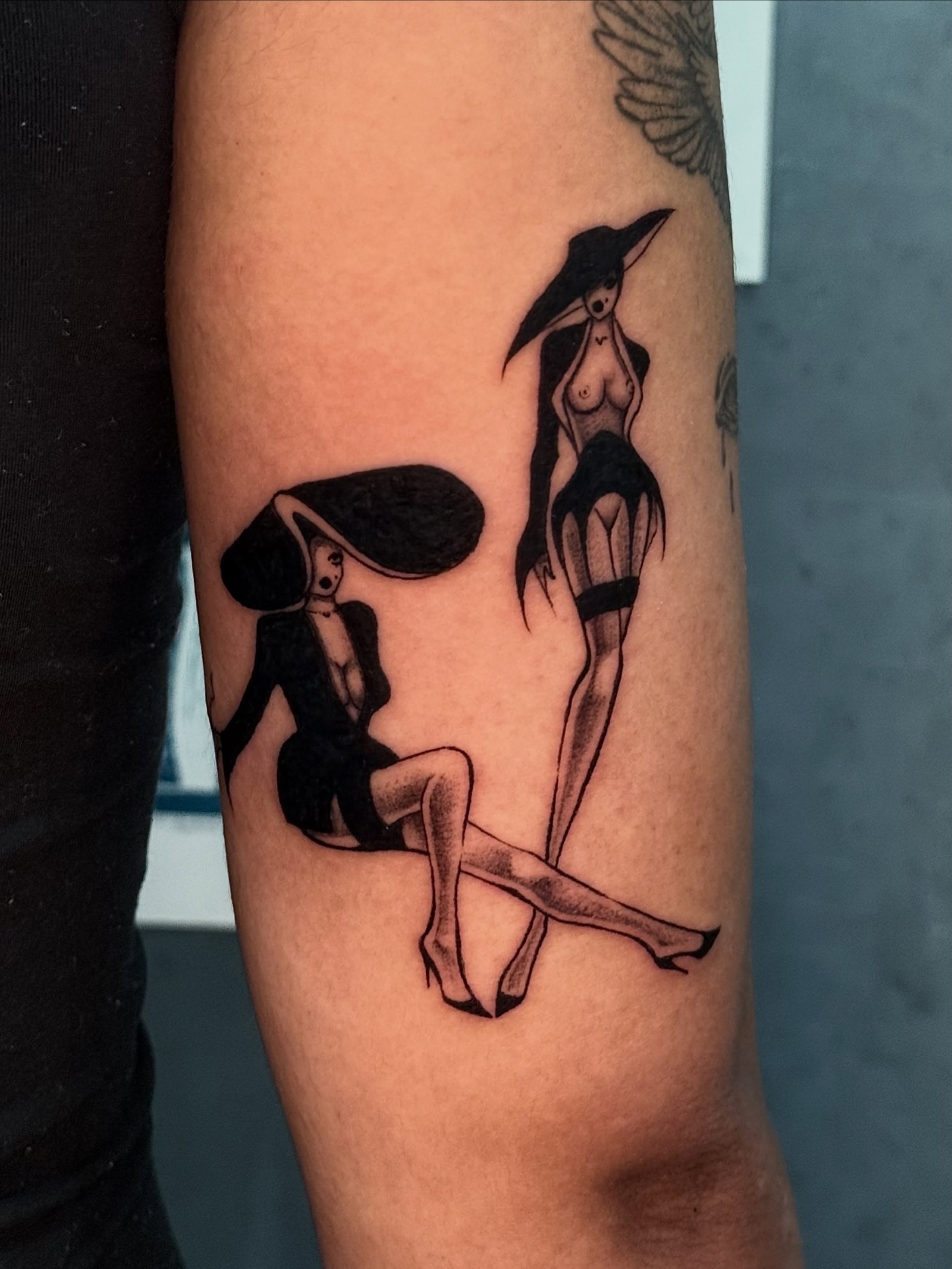 Two women in hats black and grey tattoo on the forearm by ༺♡༻ Melia’s Dolls ༺♡༻