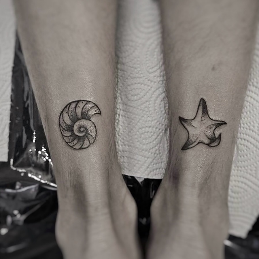 Nautilus shell and starfish black and grey tattoo on the foot by Yana Aizen