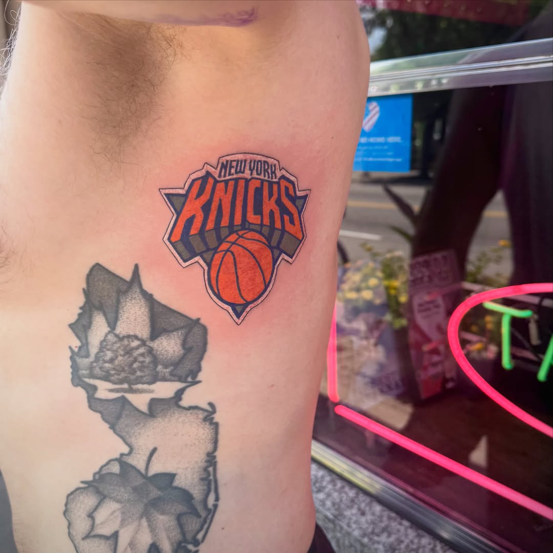 New york knicks logo American traditional tattoo on the thigh by Kylie Allen