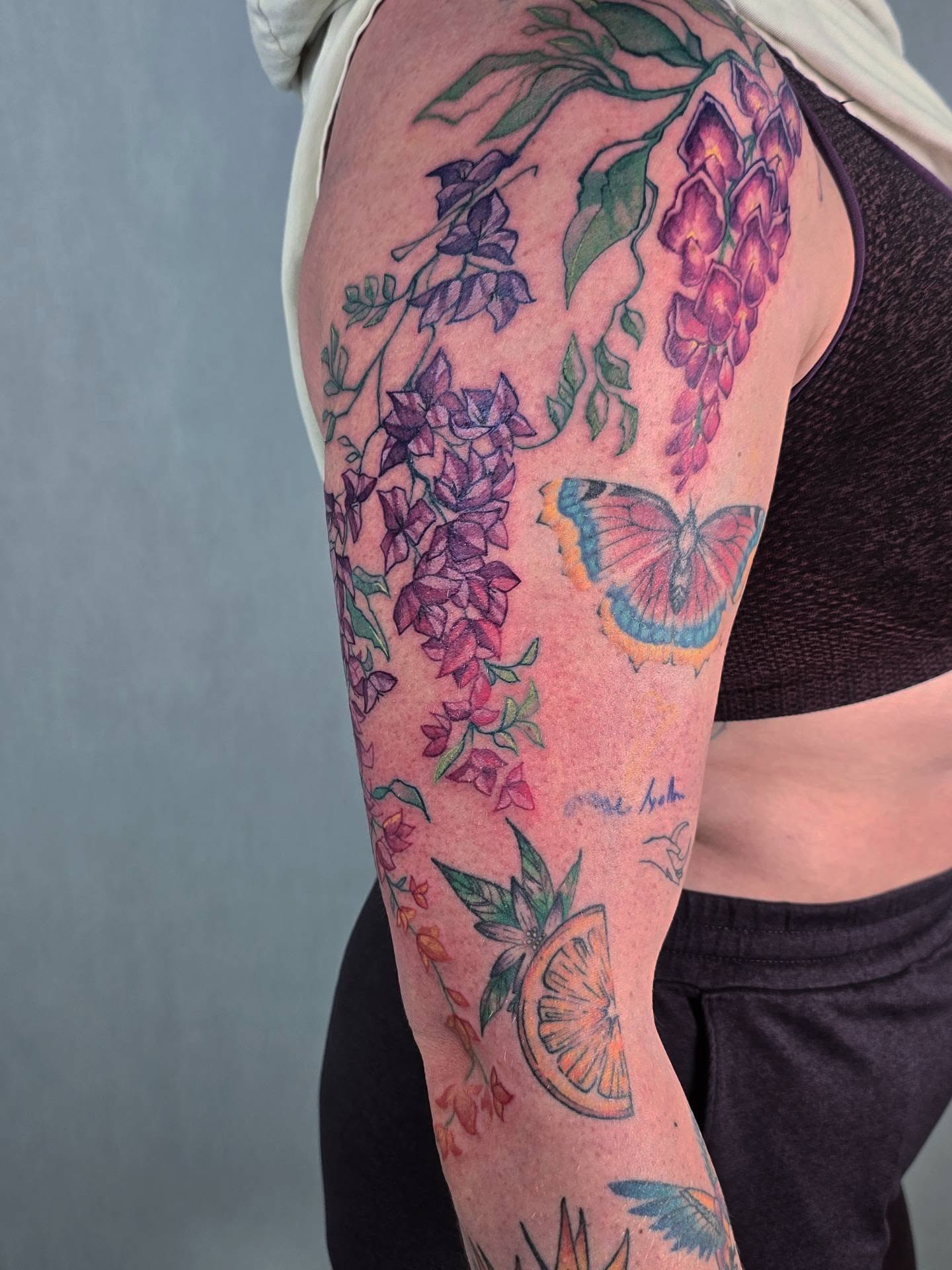 Wisteria and butterfly new school tattoo on the thigh by Tucker
