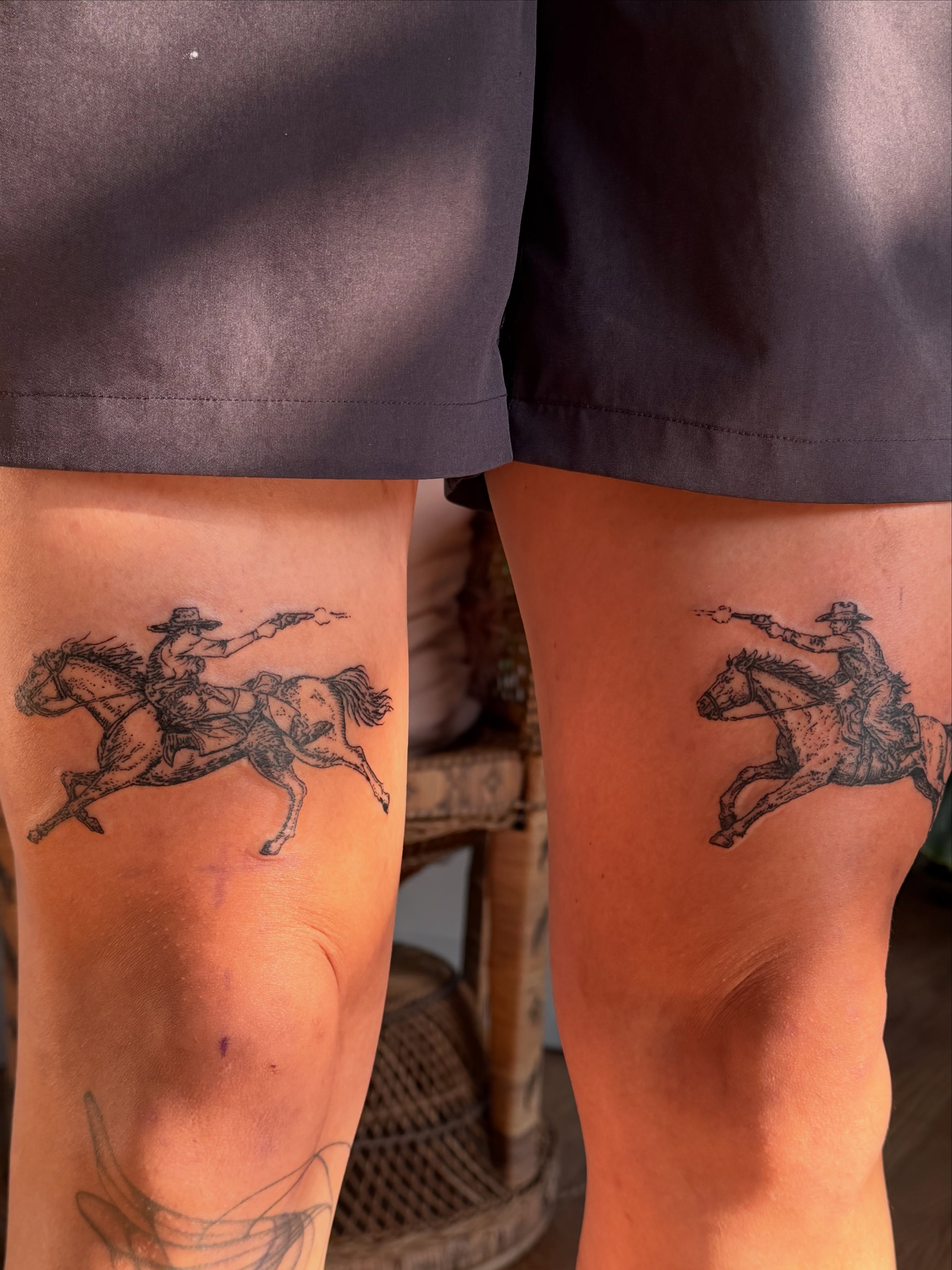 Cowboy on horseback black and grey tattoo on the thigh by Babymaxy Inks Llc