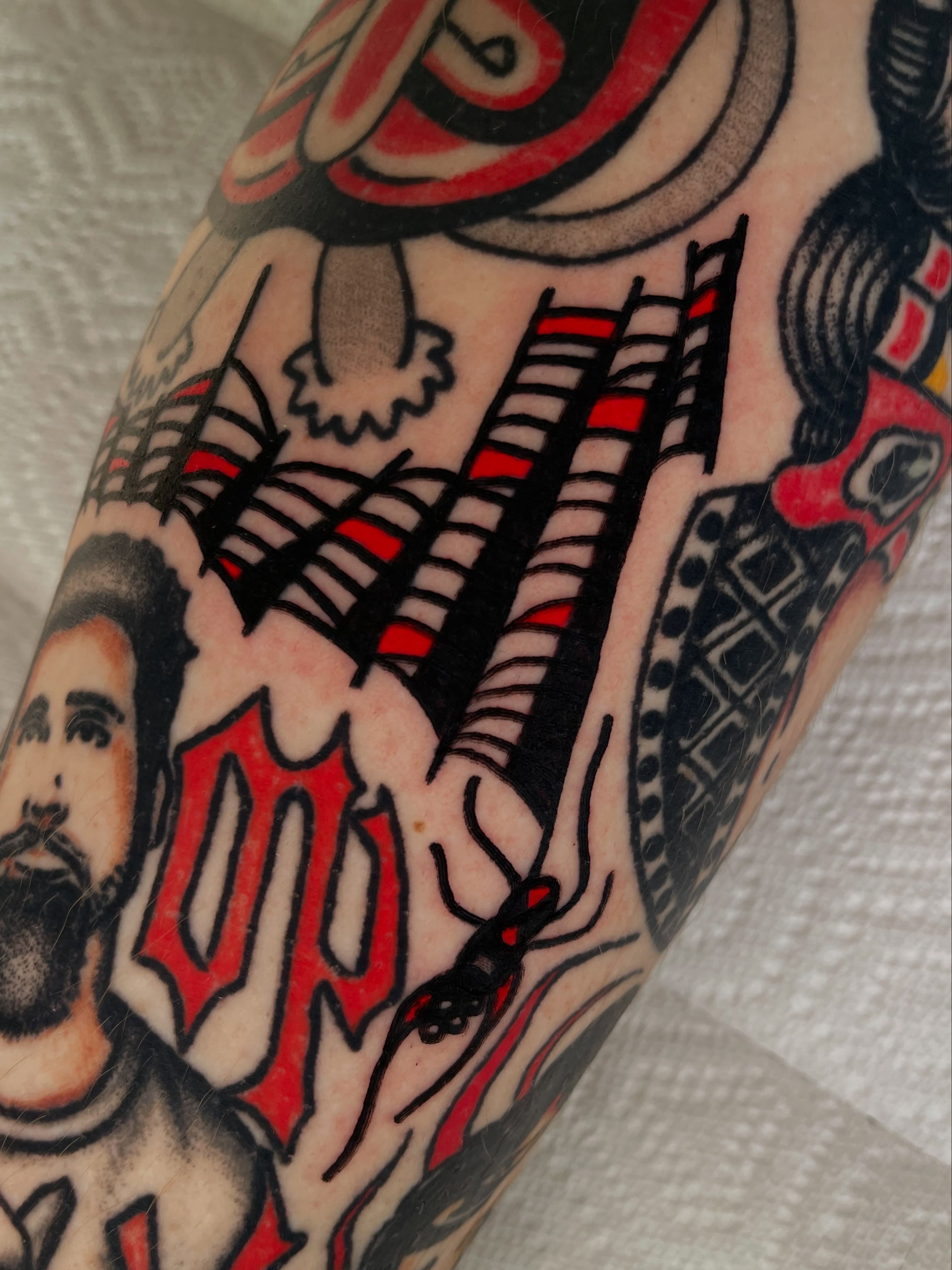Cityscape American traditional tattoo on the forearm by Devyn Hightower