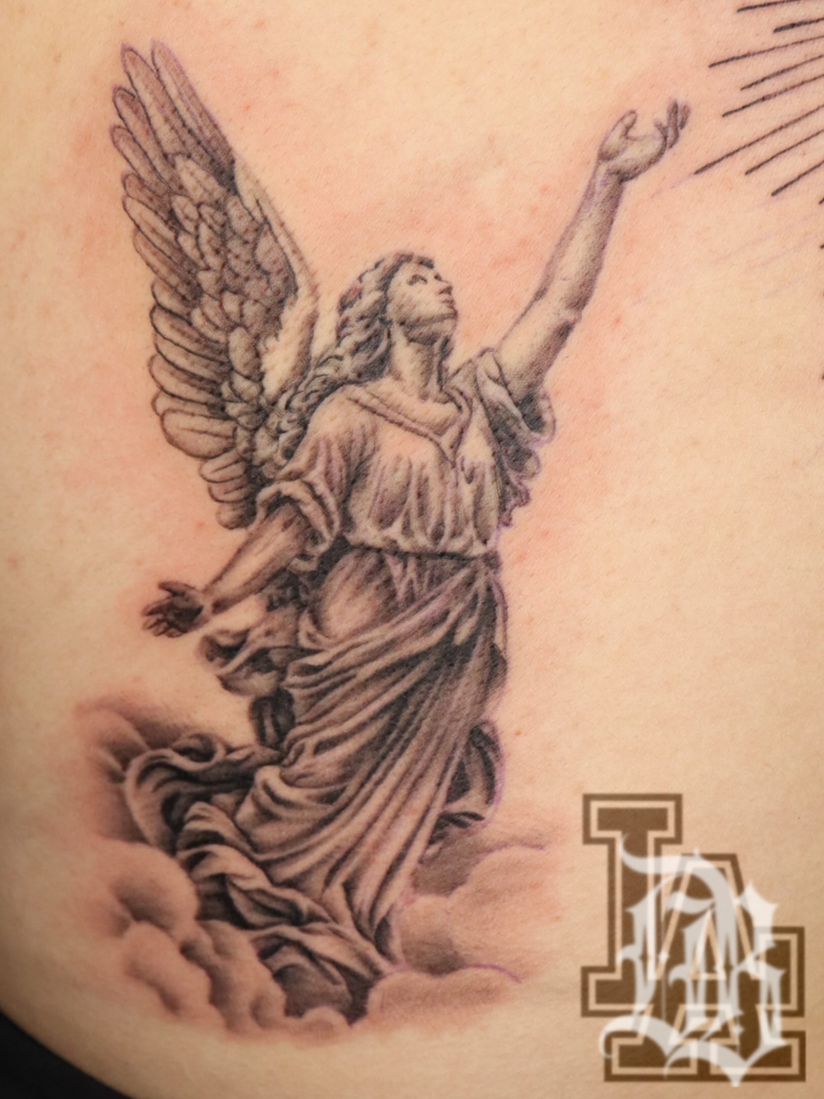 Angel black and grey tattoo on the torso by Daniel Rodriguez