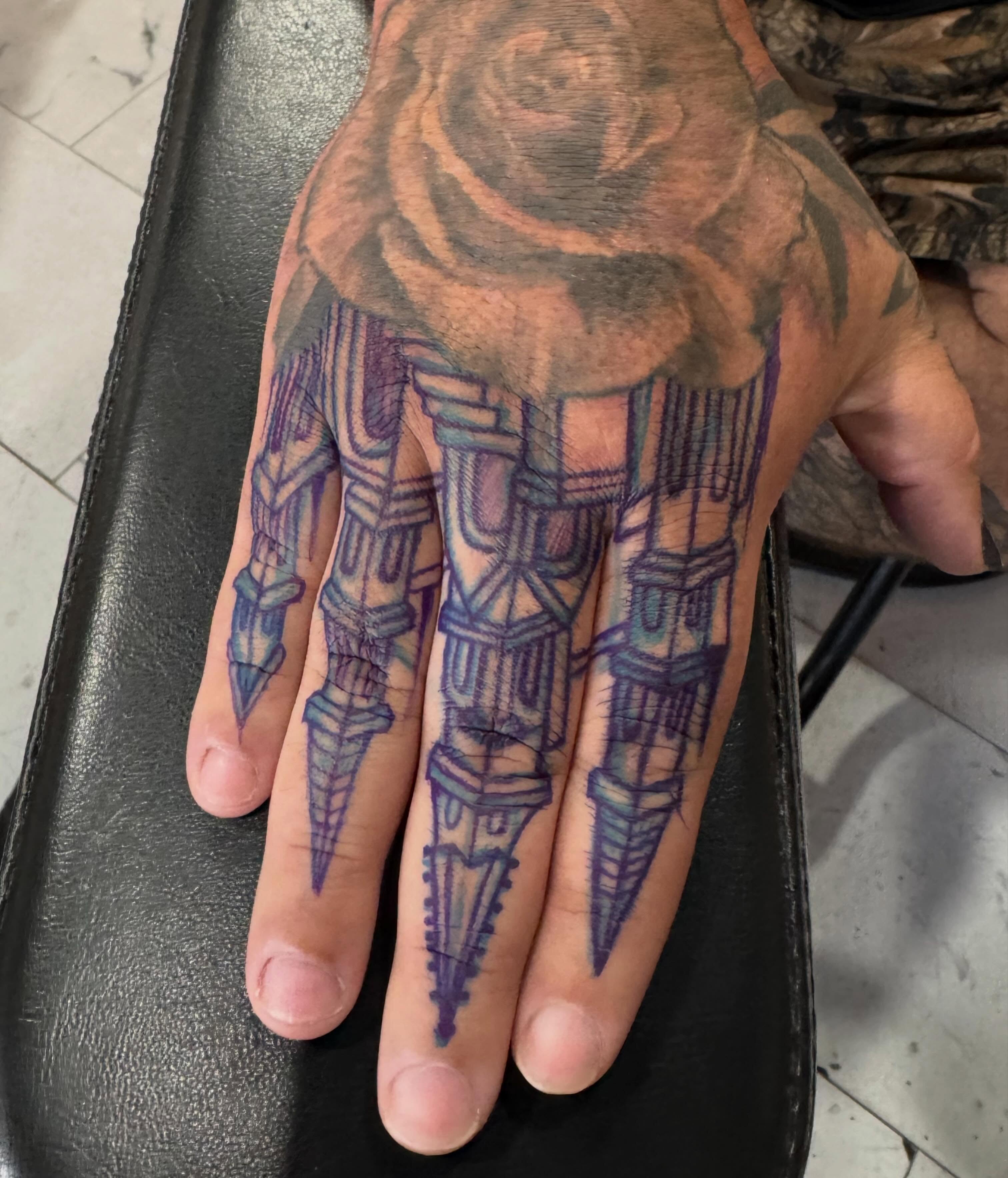 Spiked fingers geometric tattoo on the hand by Keith Smith