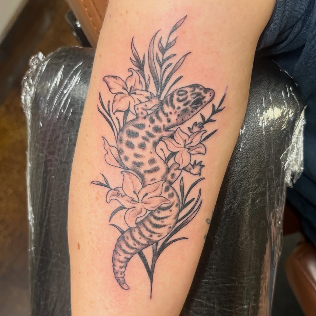 Gecko and flowers black and grey tattoo on the forearm by Gabby, Kansas City, Missouri