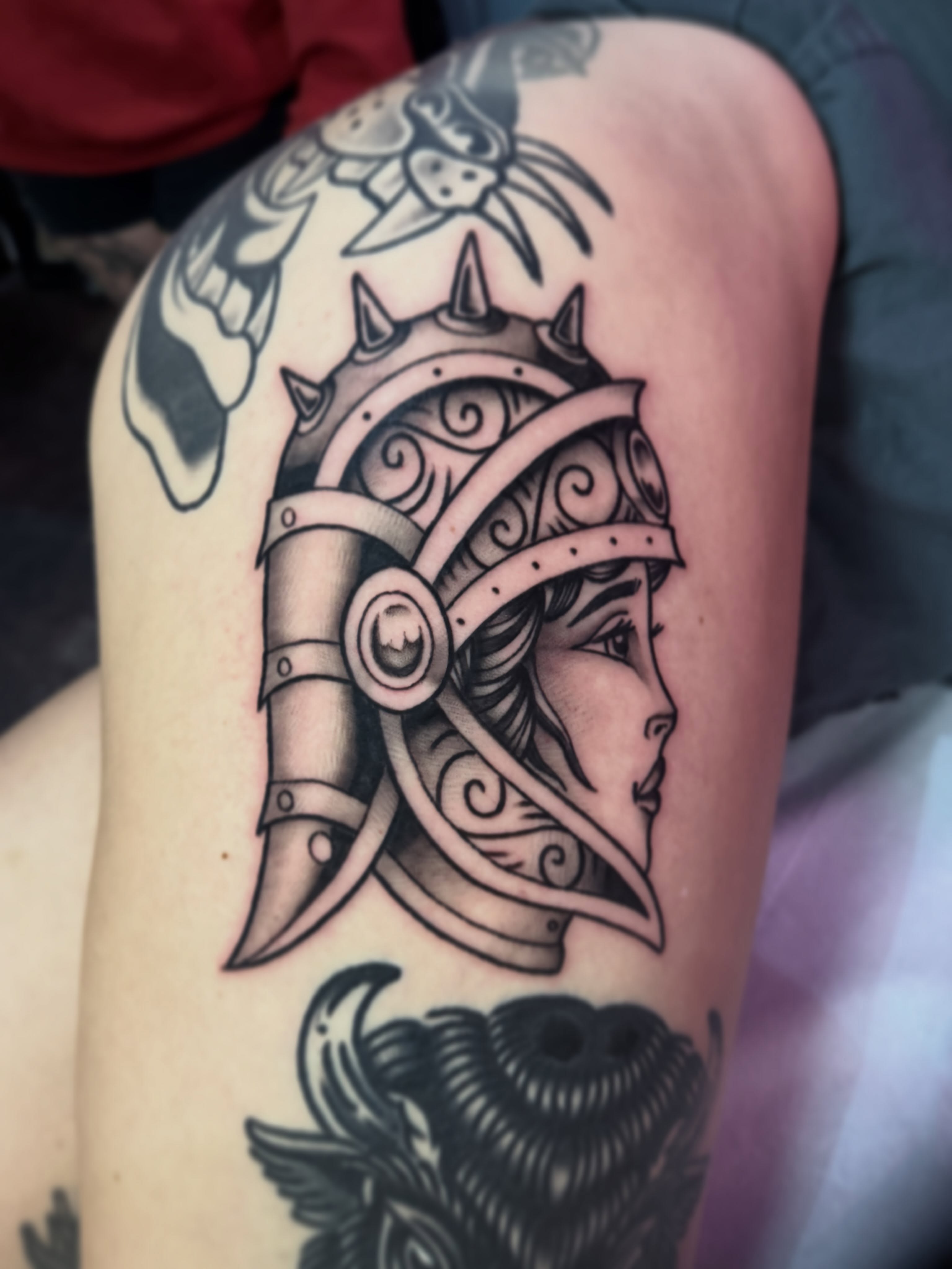 Helmeted woman American traditional tattoo on the thigh by Jacob, Marion, Illinois