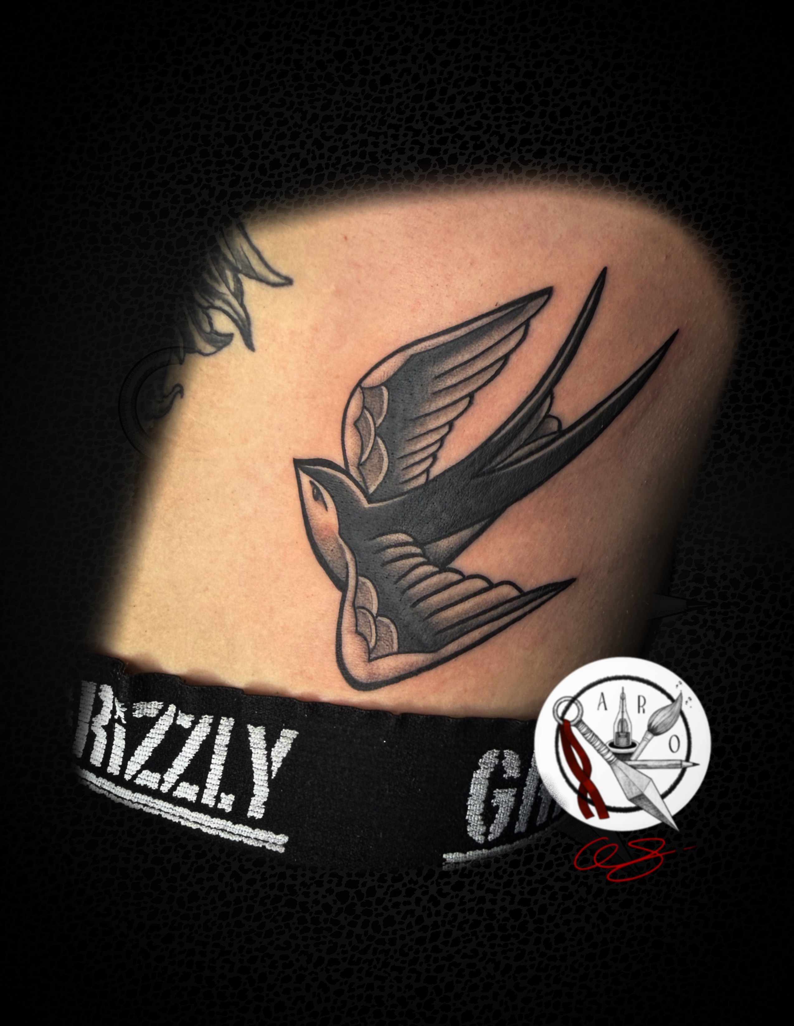 Swallow American traditional tattoo on the shoulder by Aaron Strobehn