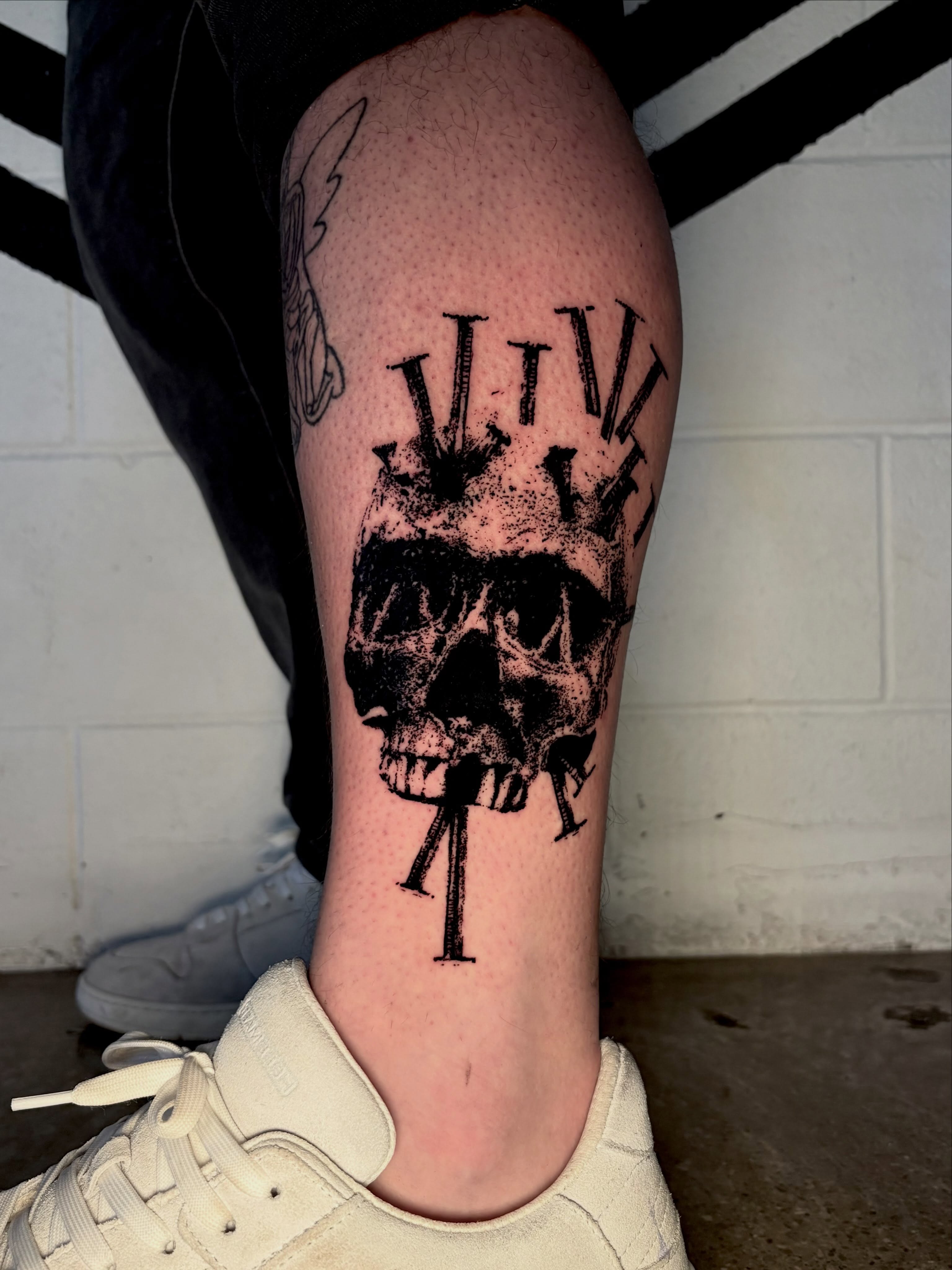 Skull with crossbones black and grey tattoo on the calf by @lil_stinker_5000, Portland, Oregon