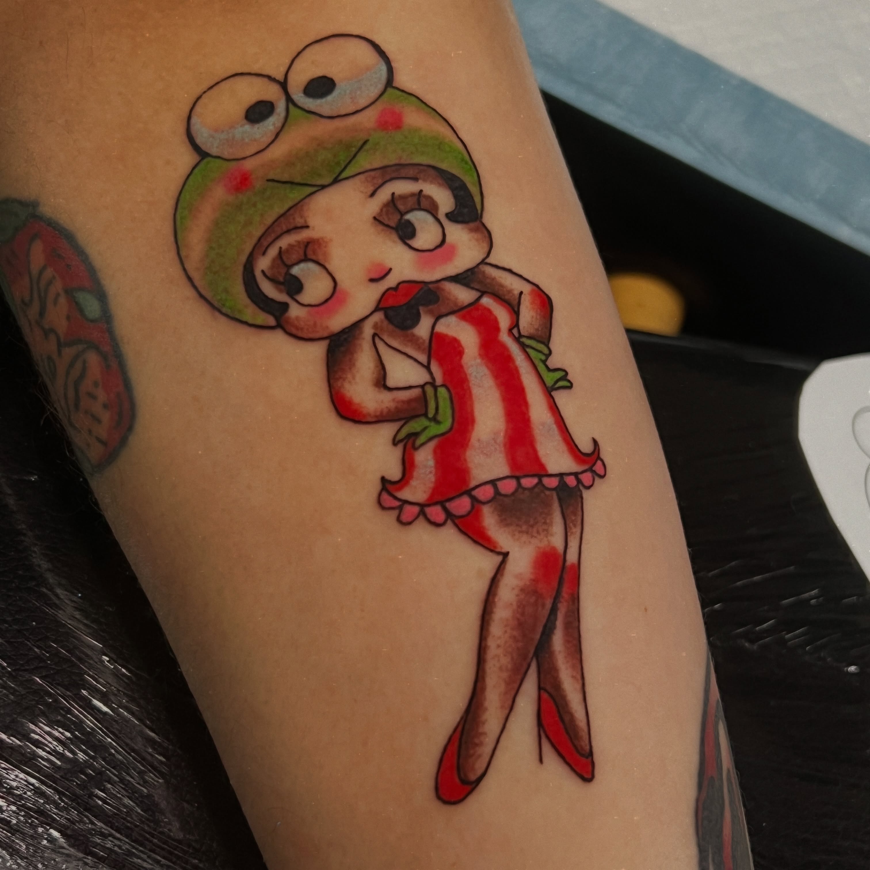Frog in dress American traditional tattoo on the forearm by Andrea Patterson