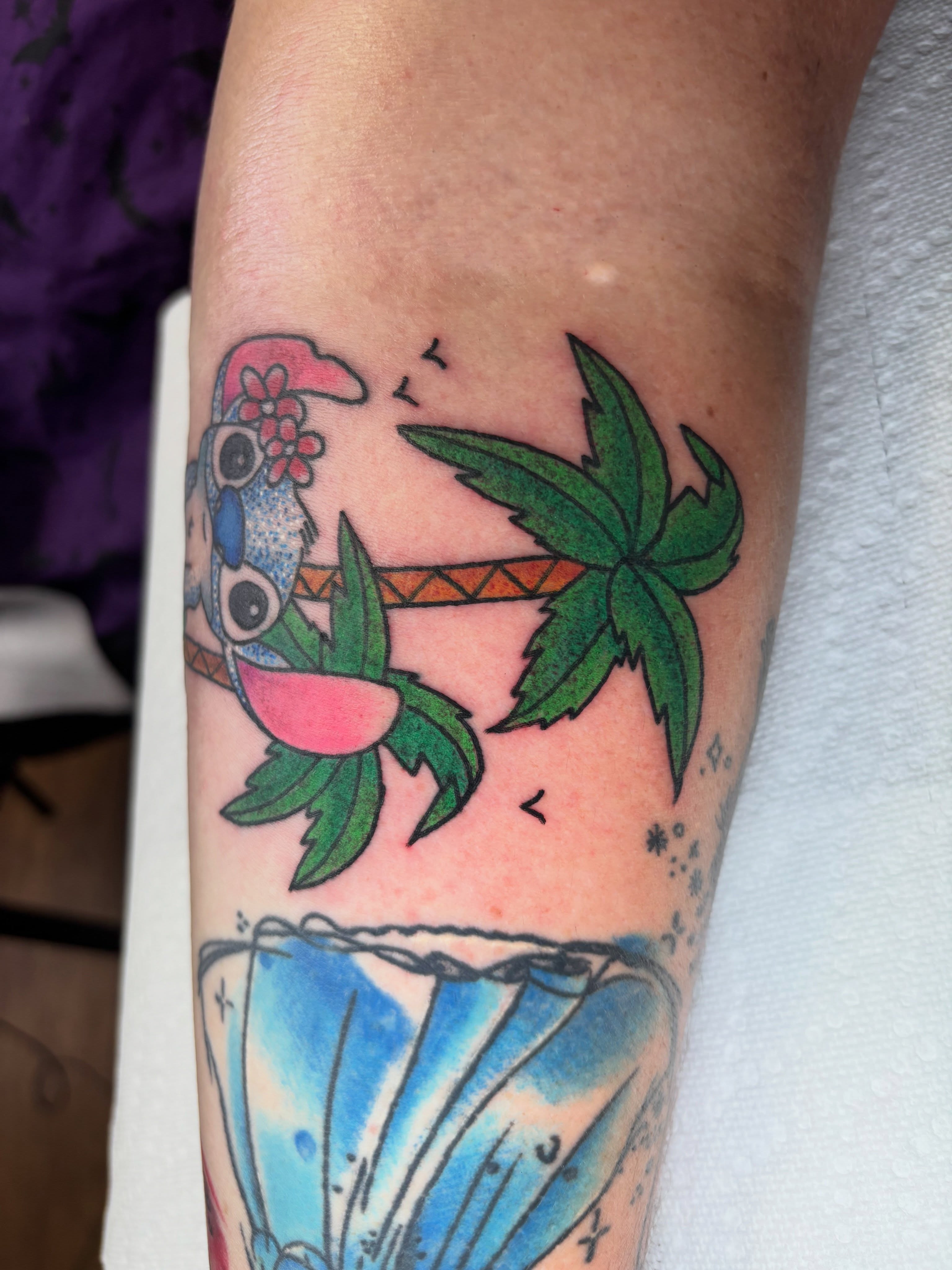 Parrot and palm tree new school tattoo on the forearm by AARON MASTERS - Tattoo Artist