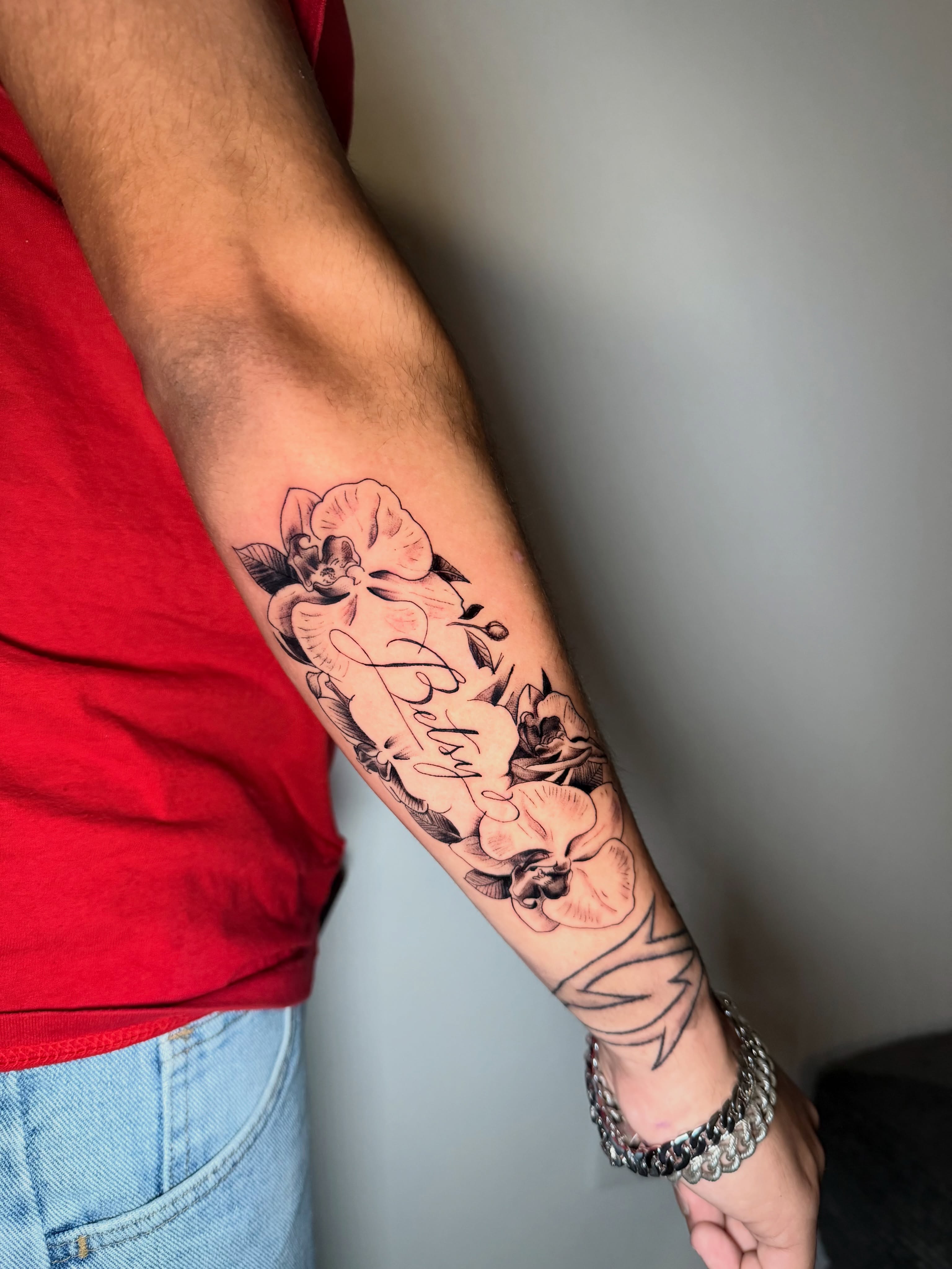Floral arrangement black and grey tattoo on the forearm by Sebastian martinez, Memphis, Tennessee