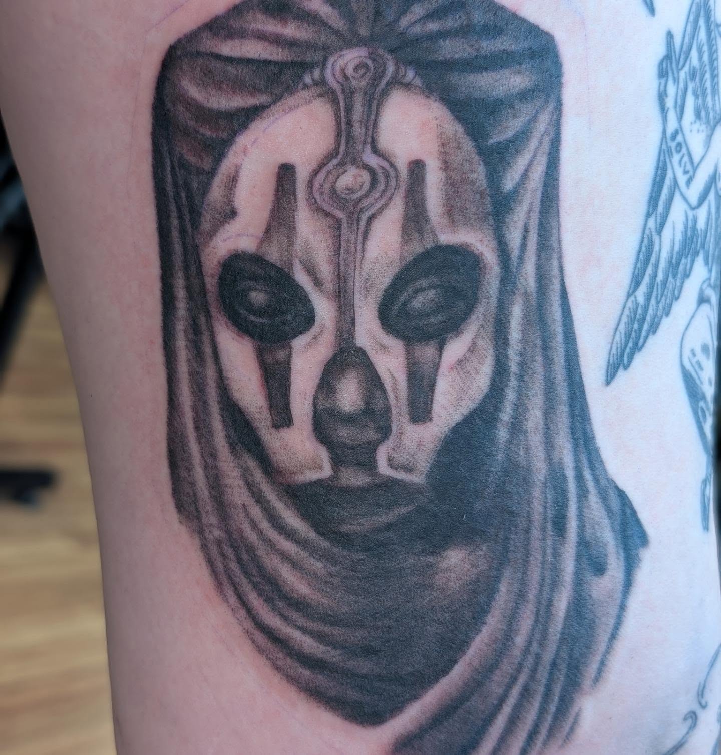 Mask realism tattoo on the forearm by Chad Nuber