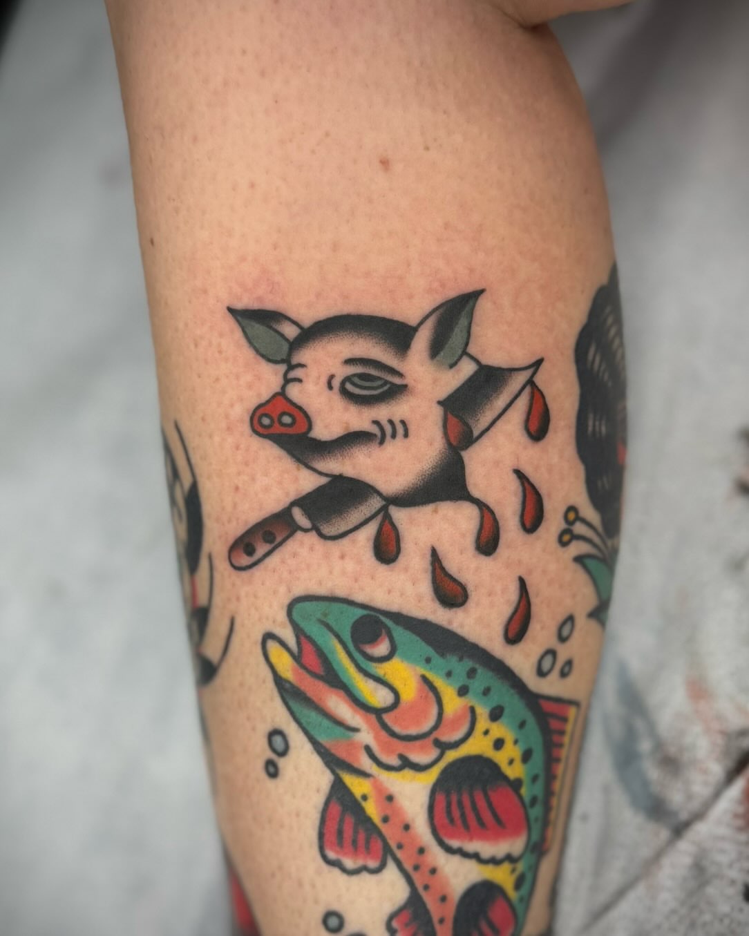 Pig and fish American traditional tattoo on the forearm by kalli berry