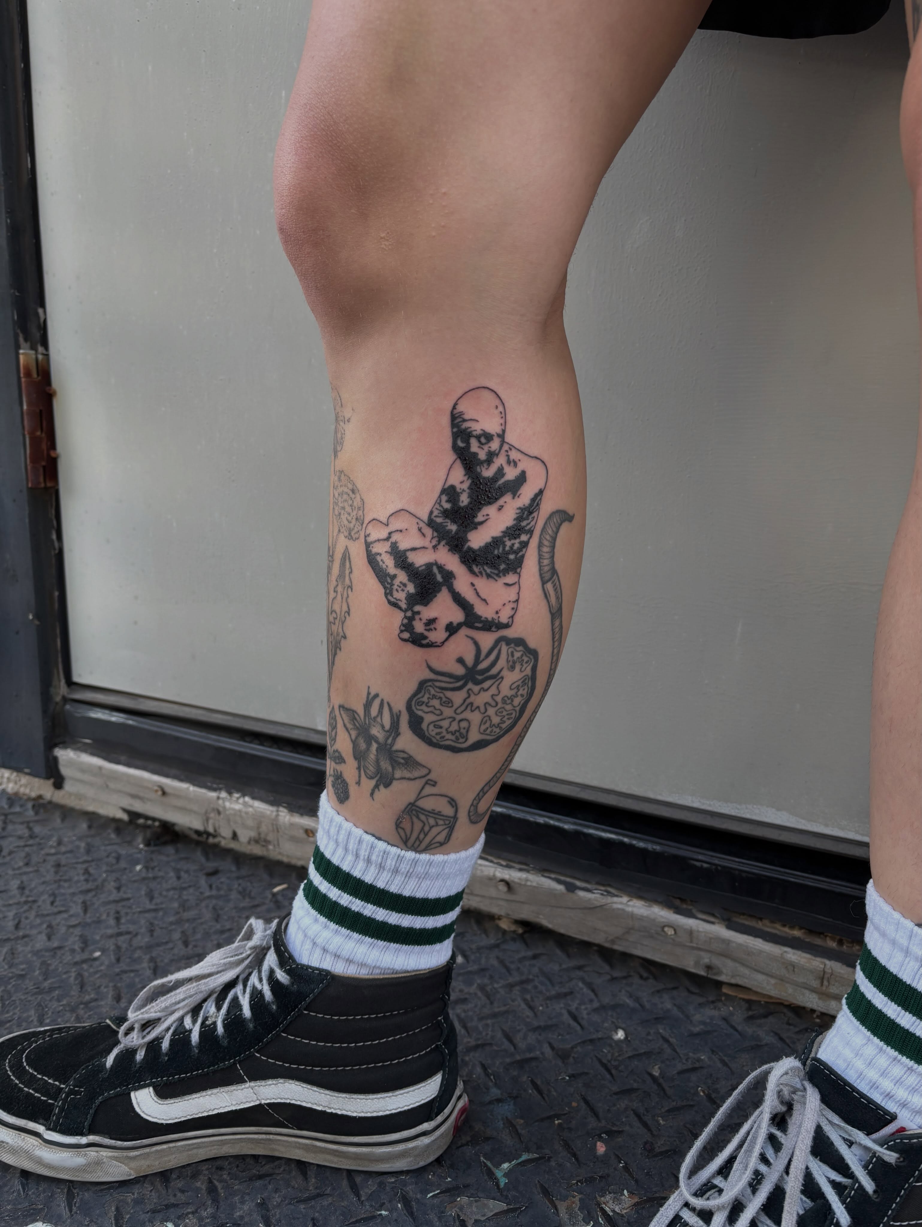 Man with snake black and grey tattoo on the calf by Turner