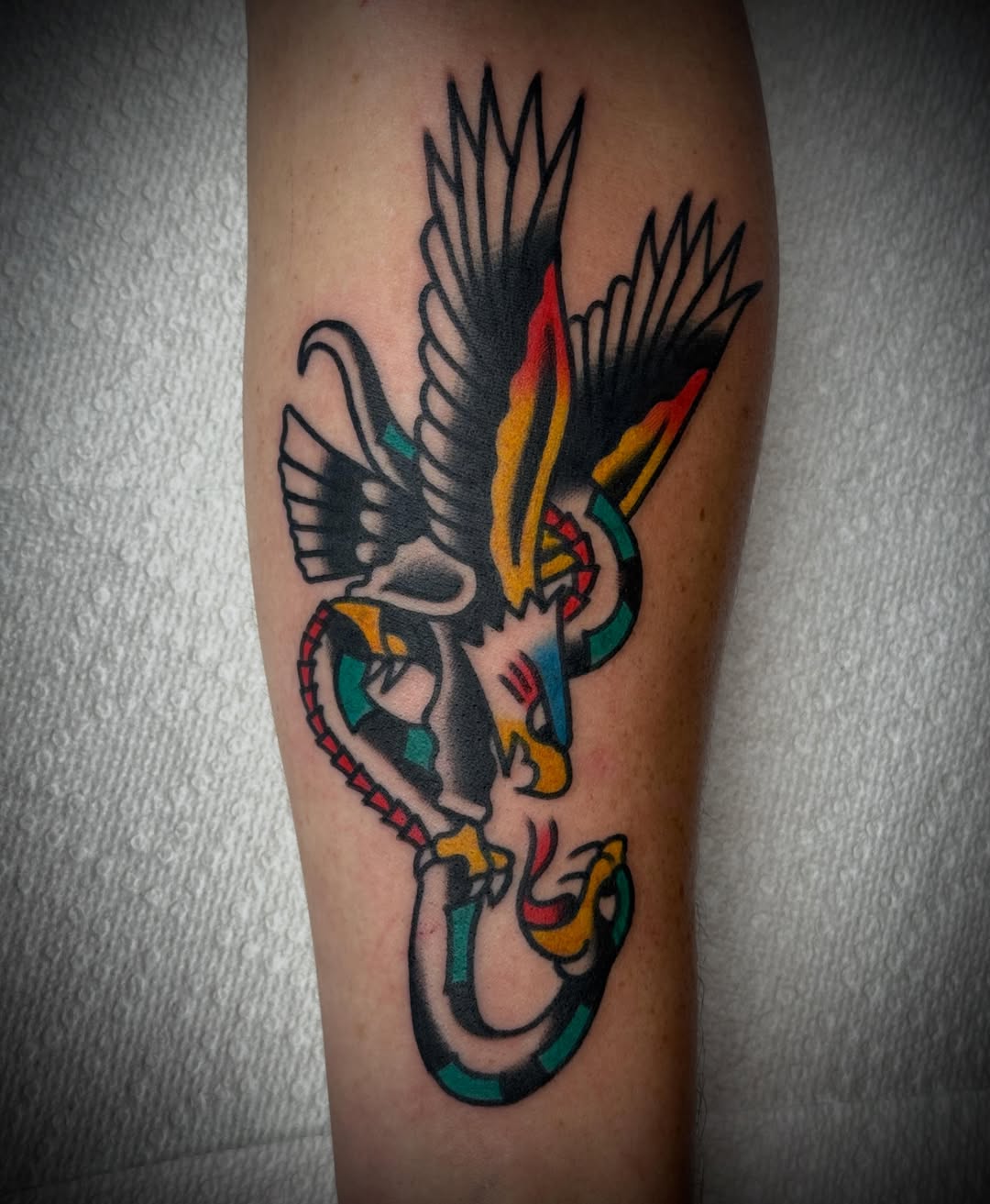 Bird and snake American traditional tattoo on the forearm by Tristan Bradshaw
