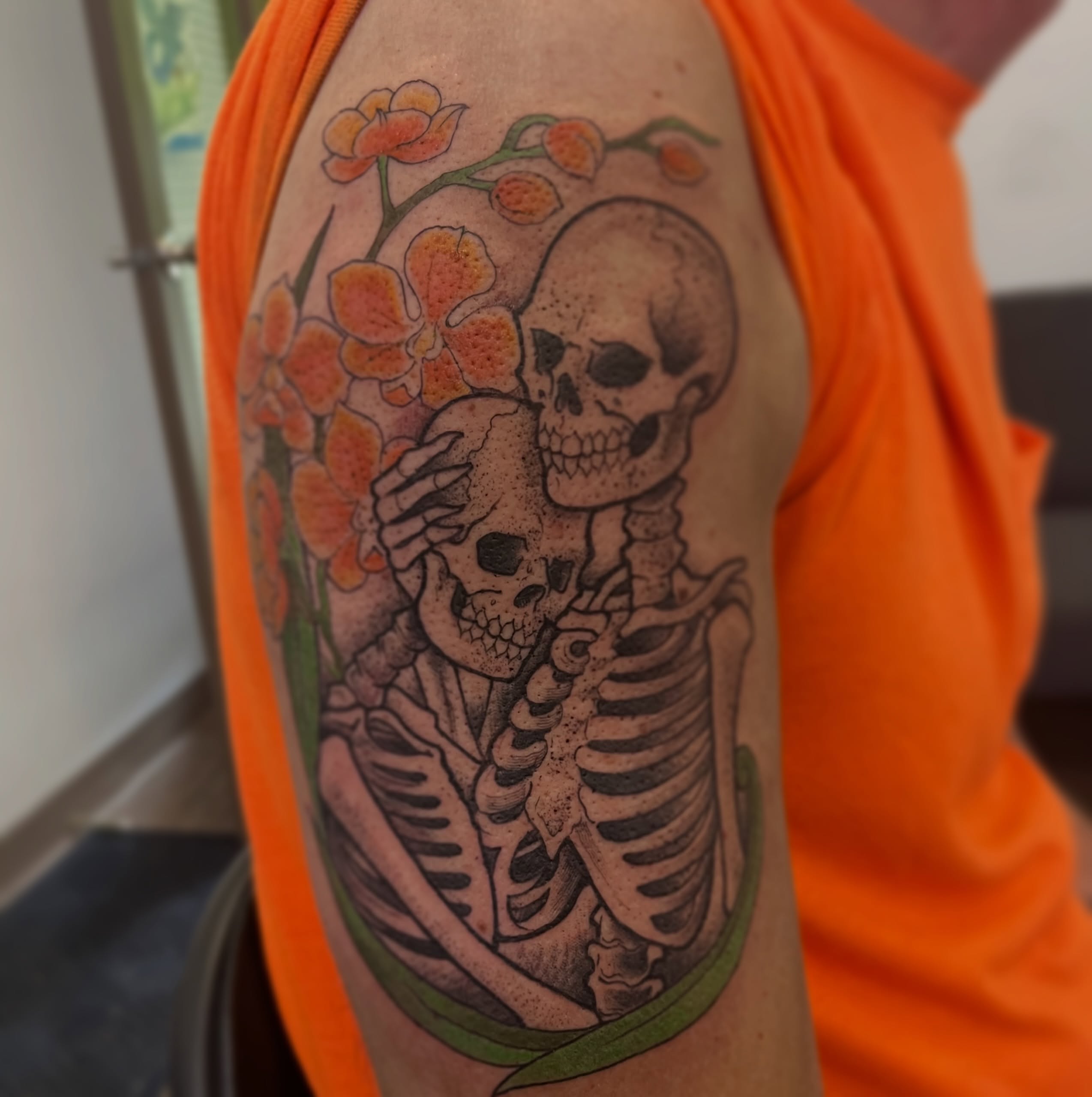 Skeleton couple with flowers realism tattoo on the upper arm by Lacey B, Portland, Oregon