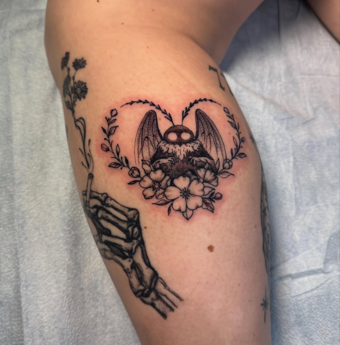 Bat and flowers black and grey tattoo on the forearm by C.J. Pennington