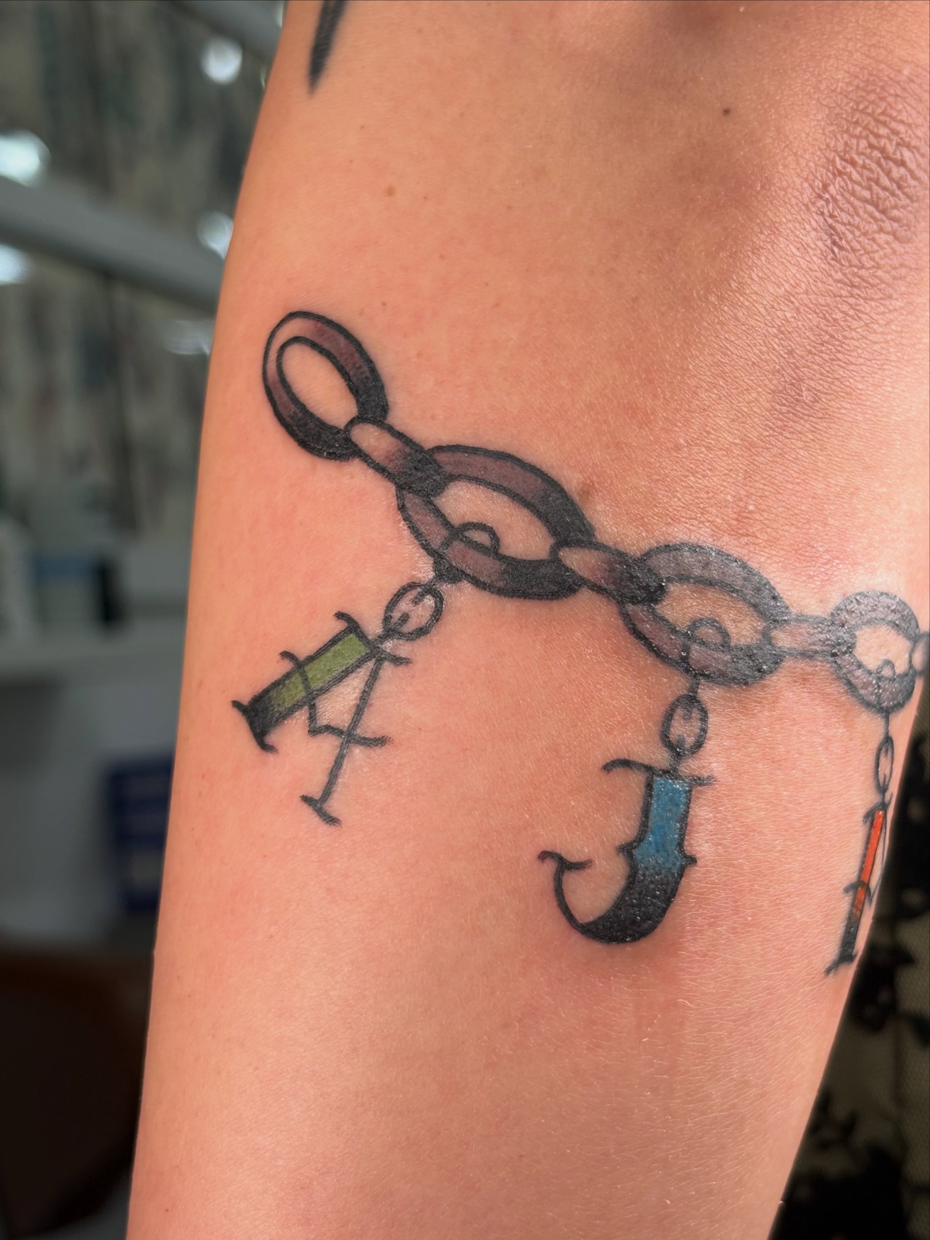 Chain and syringe black and grey tattoo on the forearm by Aysia Mankin-Wong, San Francisco, California