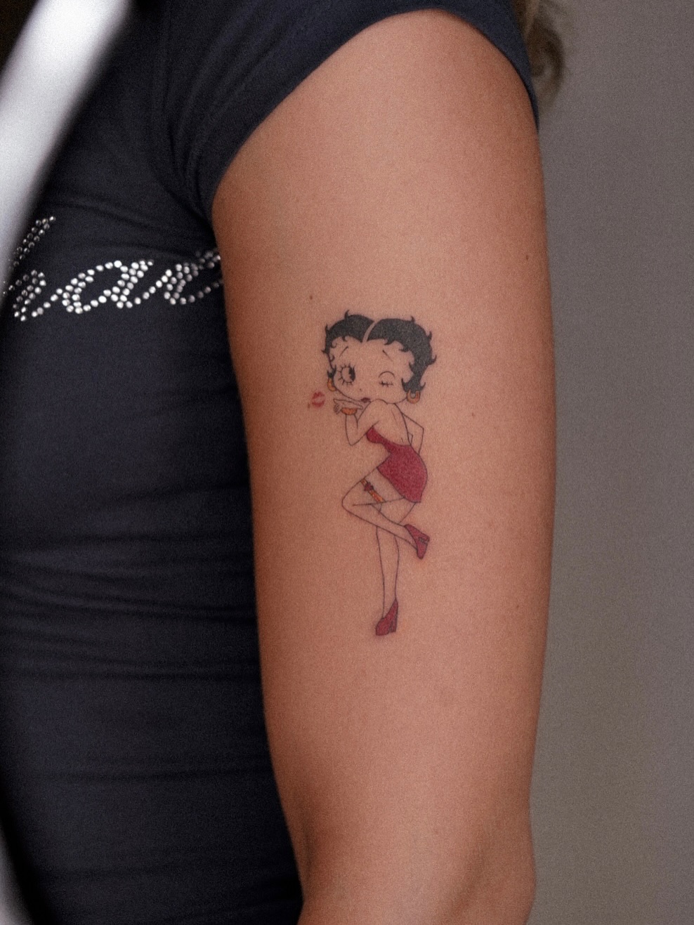 Betty Boop illustrative tattoo on the forearm by Joy Christiana
