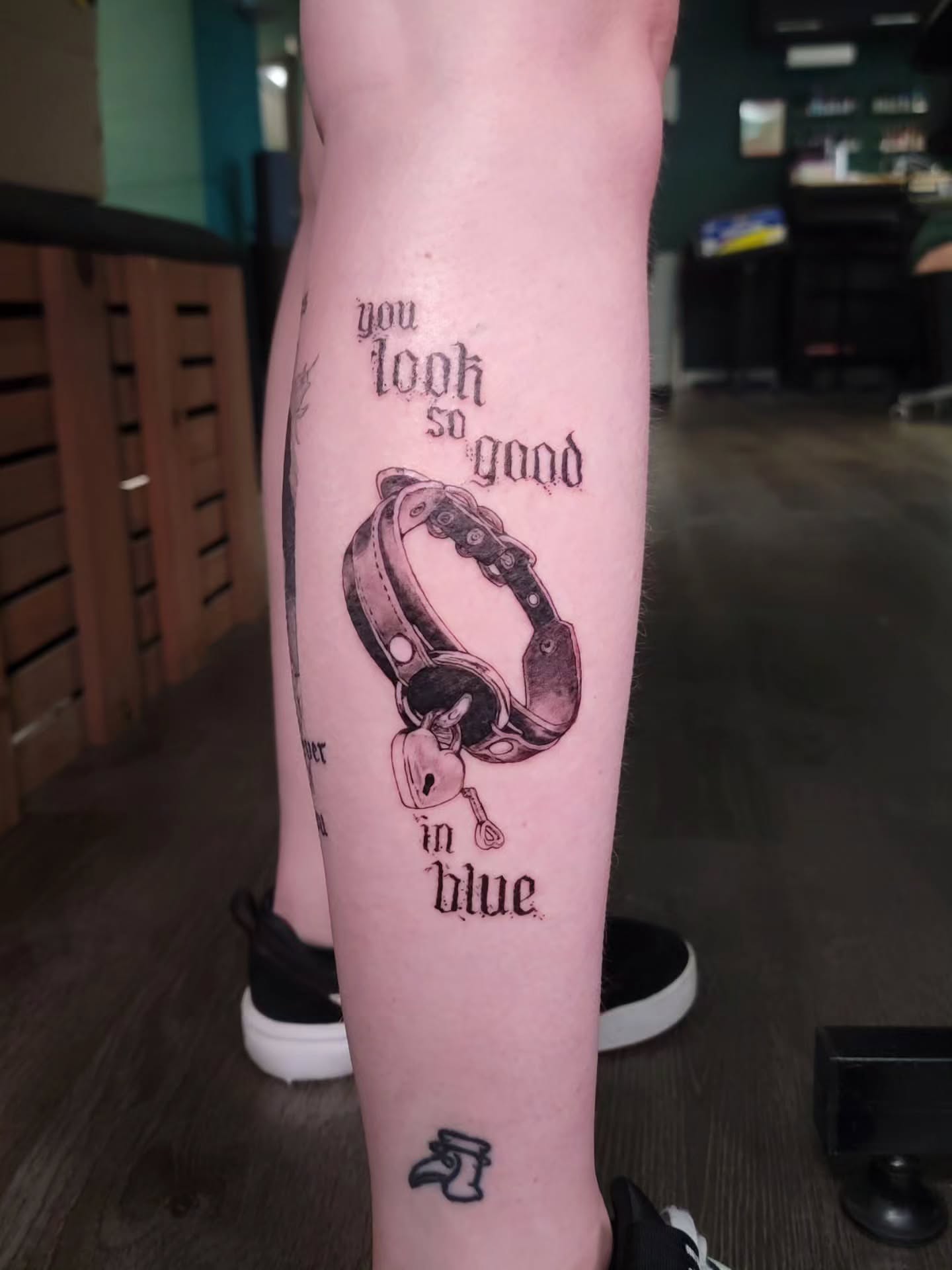 Dog collar black and grey tattoo on the forearm by Nathan Harkins-Oberbeck
